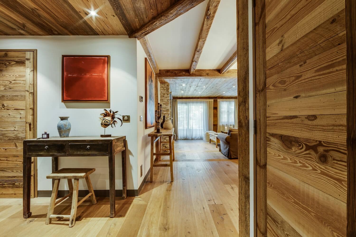 Hallway entrance with writing desk and reclaimed wood paneling