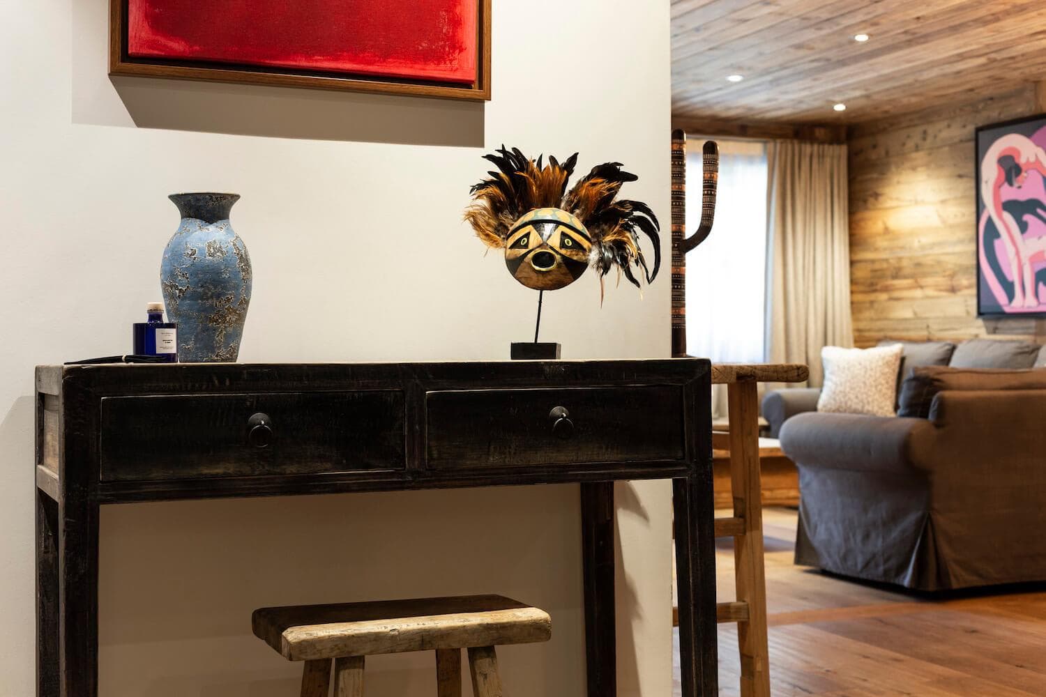 Entryway console table leading into main living area with reclaimed wood walls