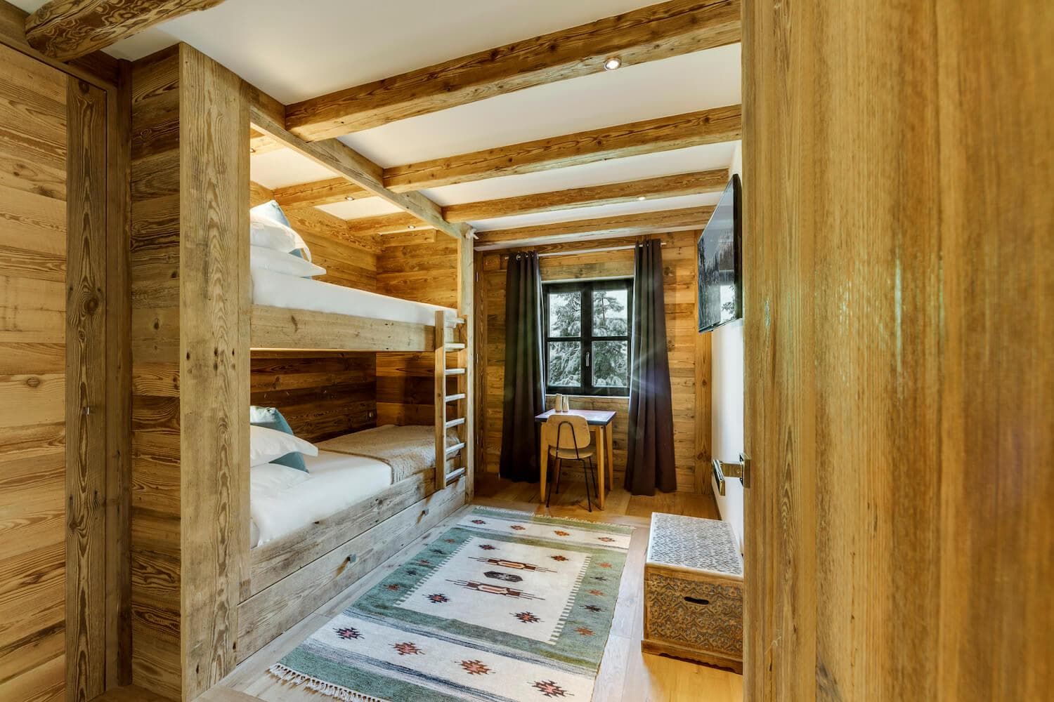 Bunk room with built-in twin beds and dedicated workstation