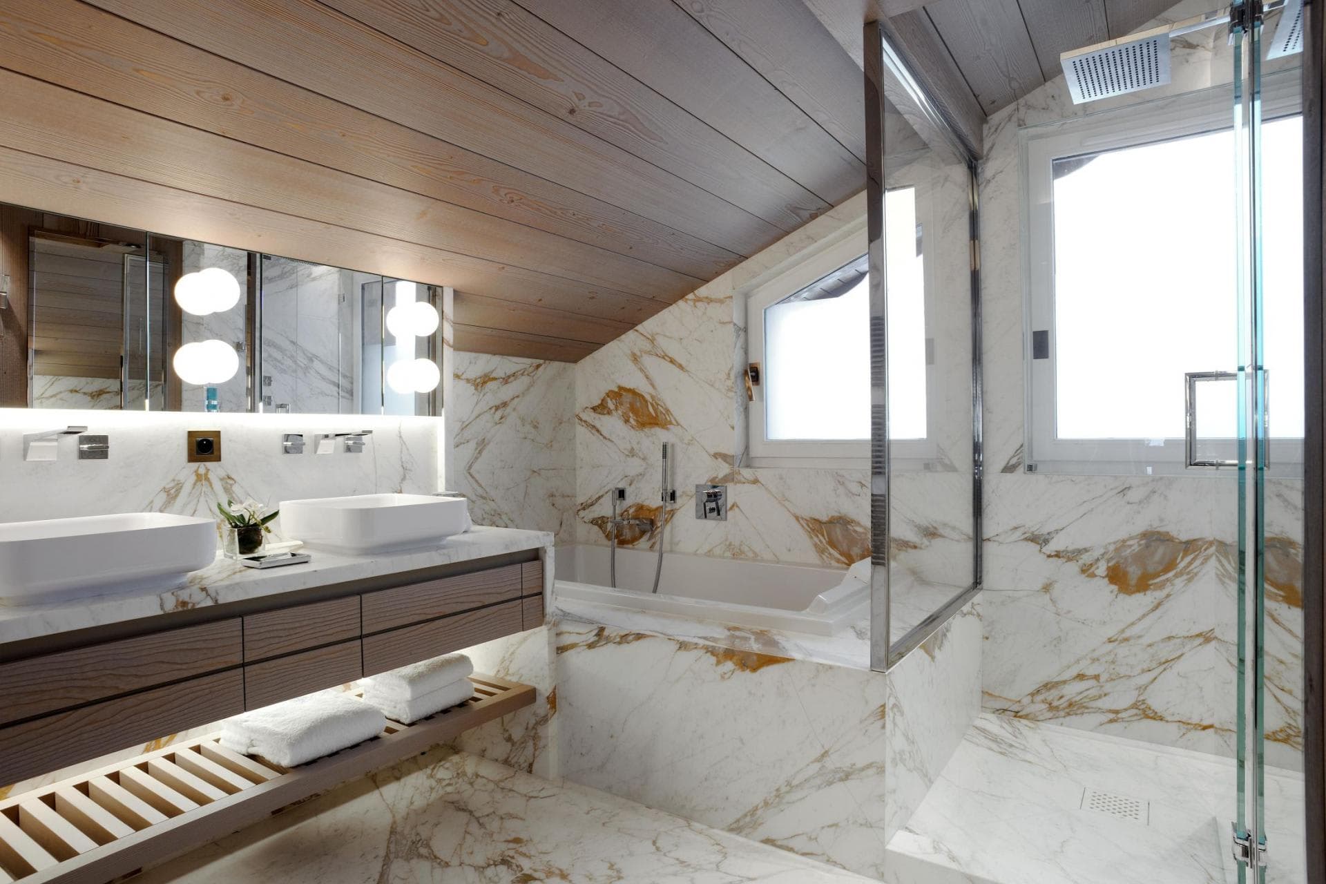 Bathroom with dual vanity, soaking tub, and separate rainfall shower