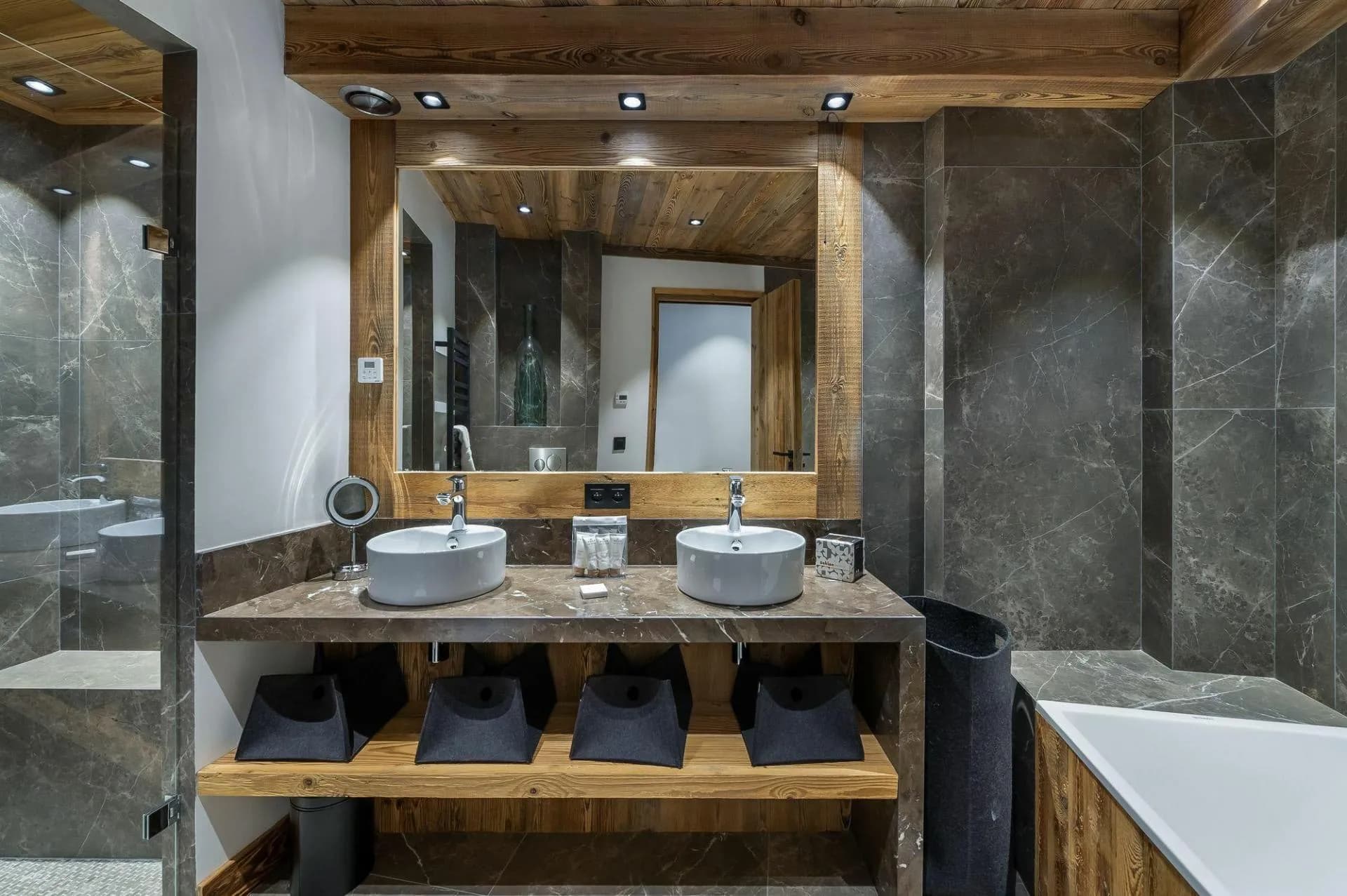 Bathroom with dual vessel sinks, walk-in shower, and soaking tub