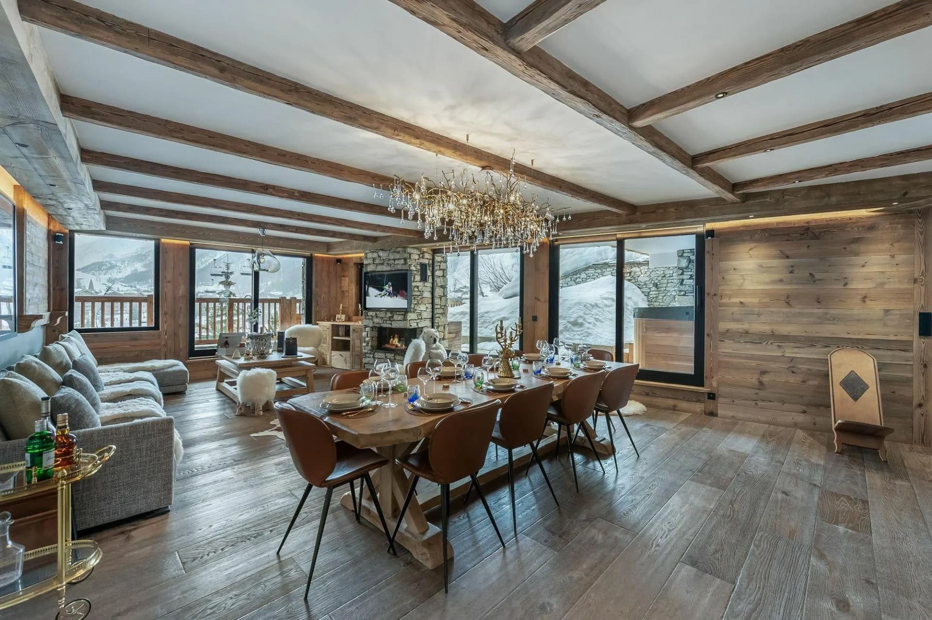 Open-plan dining and living area with a gas fireplace and mountain views