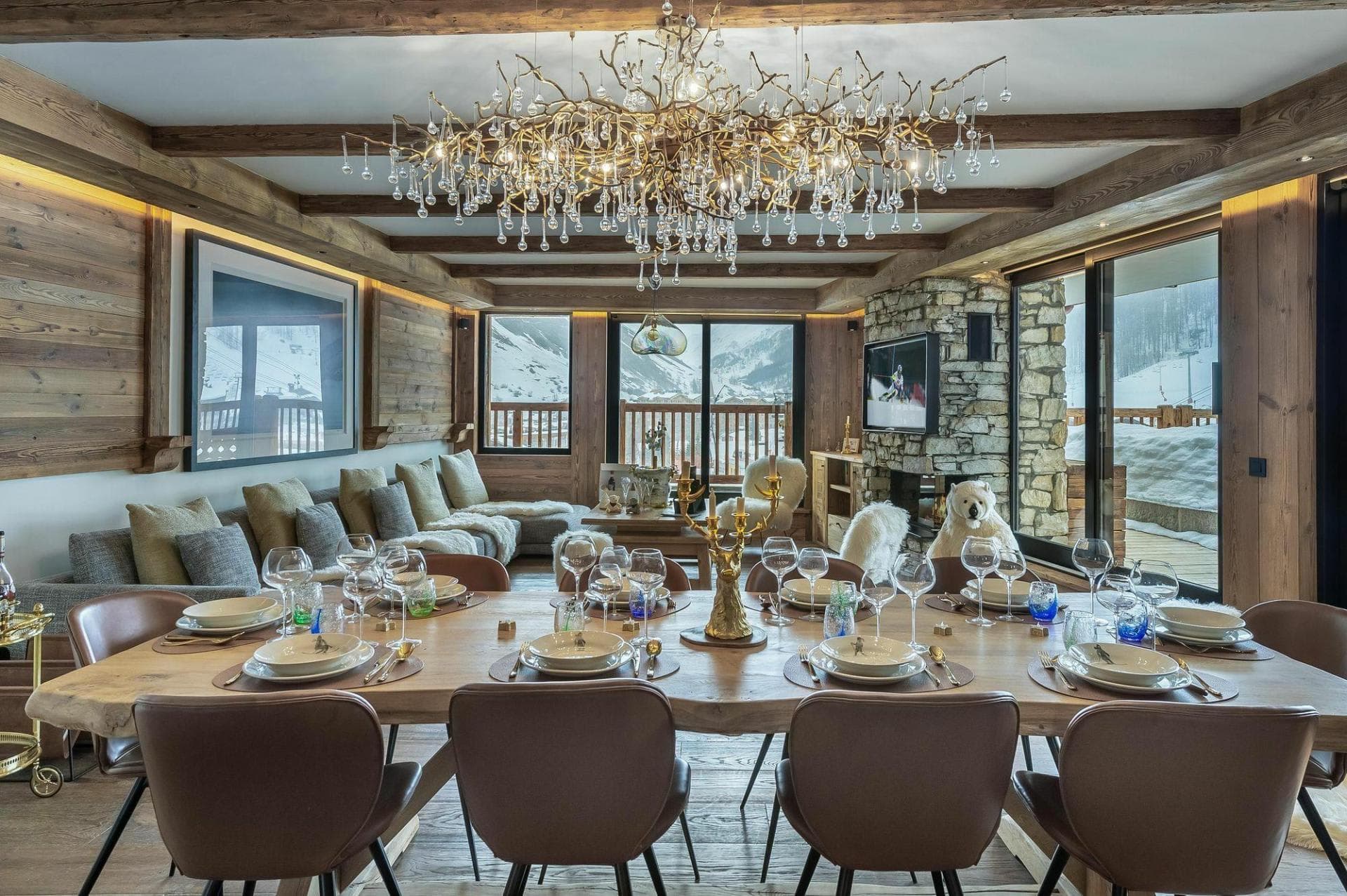 Open-concept dining and living area; table seats 10 with slope views