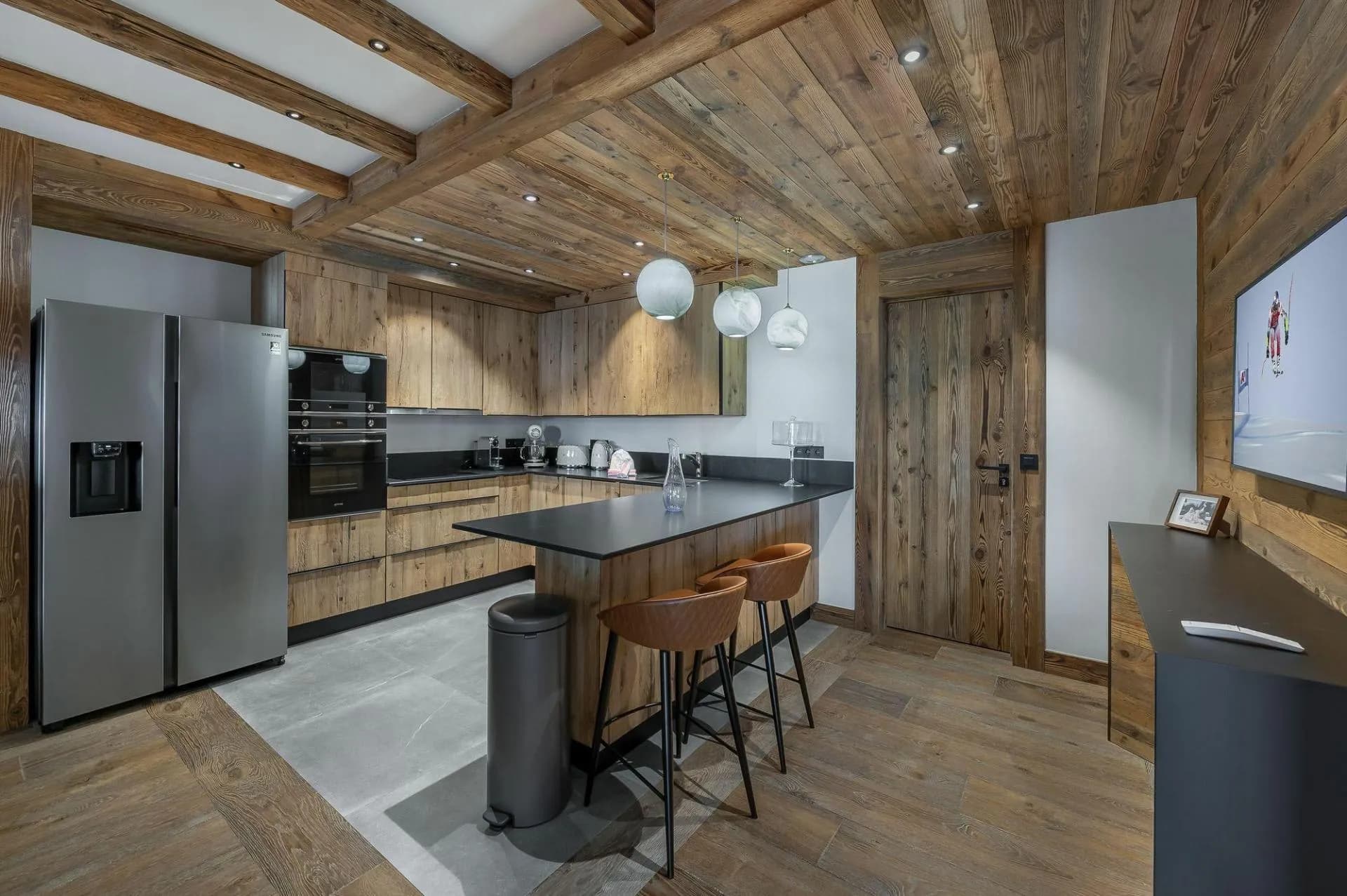 Kitchen with Samsung French door refrigerator and breakfast bar seating