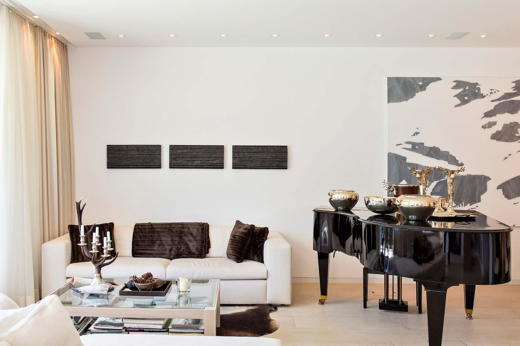 Living room with baby grand piano and recessed lighting
