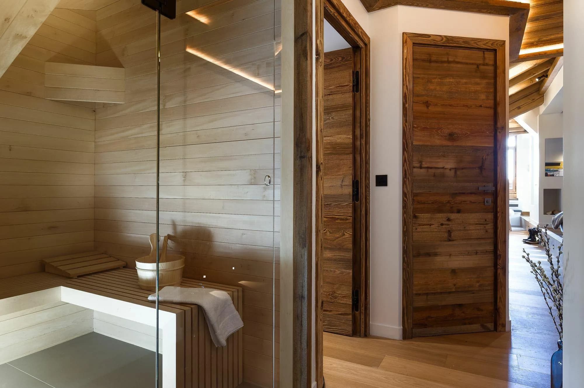 Private cedar sauna with glass door and integrated bench seating
