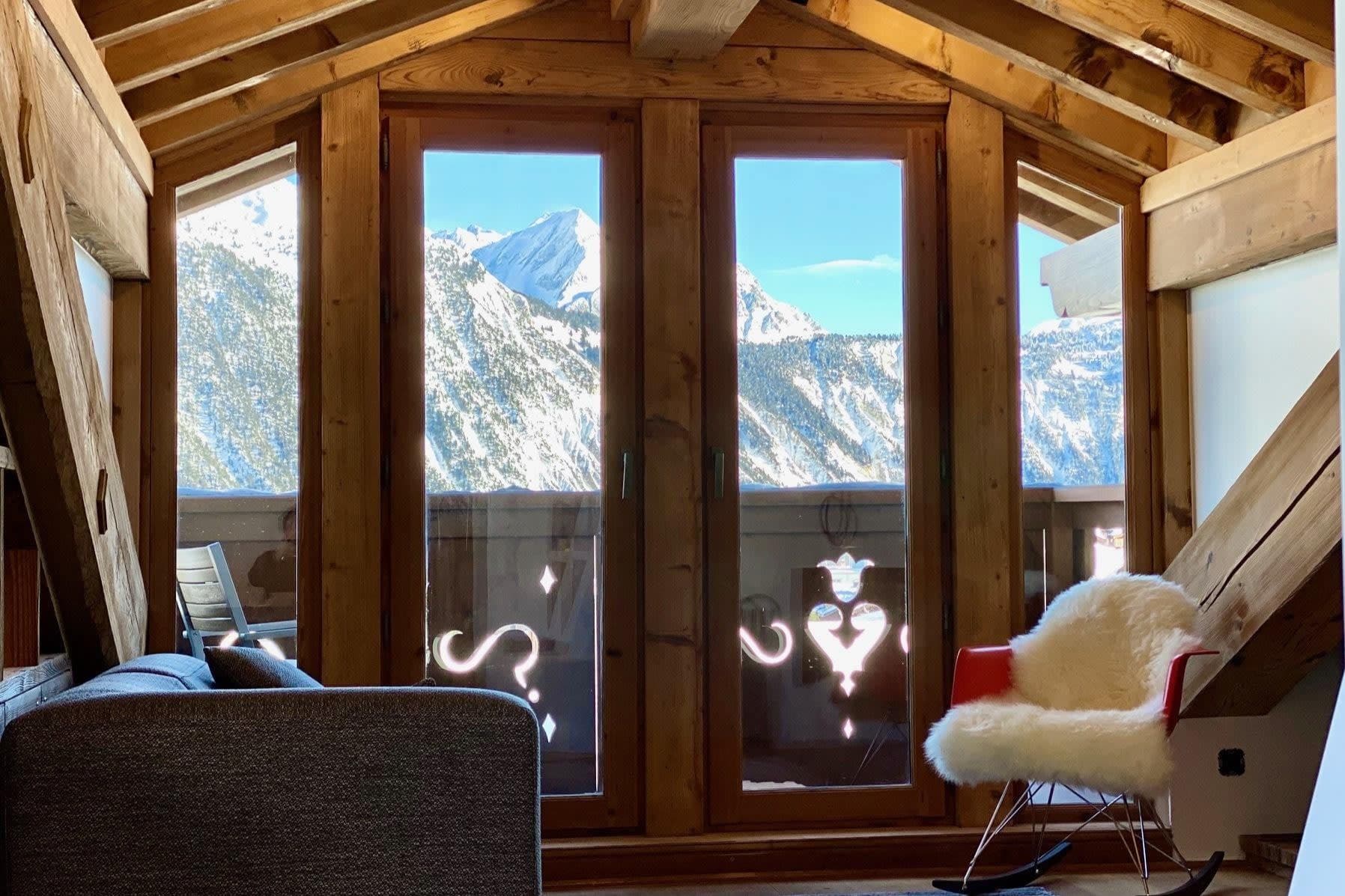Loft sitting area with mountain views and private balcony access