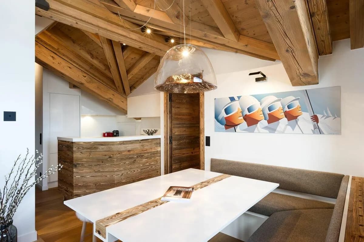 Dining area with banquette seating and exposed timber beams