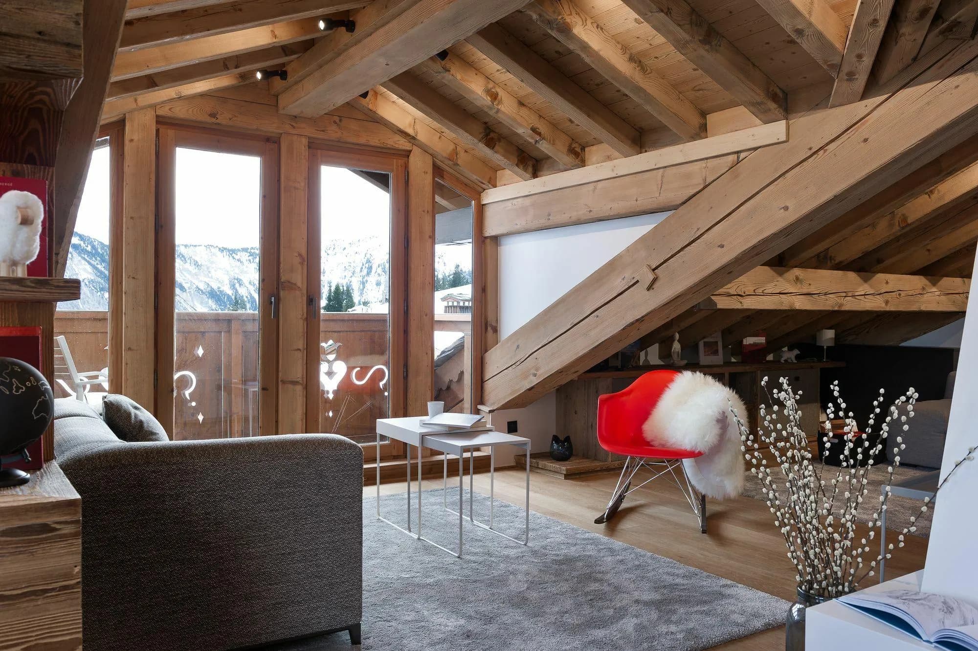 Attic lounge with vaulted timber ceilings and mountain views