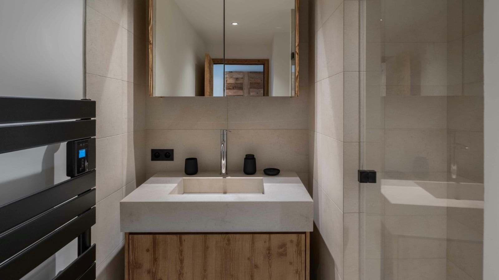 Bathroom featuring heated towel rail and stone vessel sink