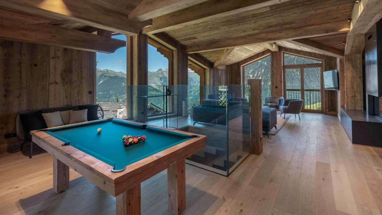 Upper floor game room with pool table and mountain-view lounge