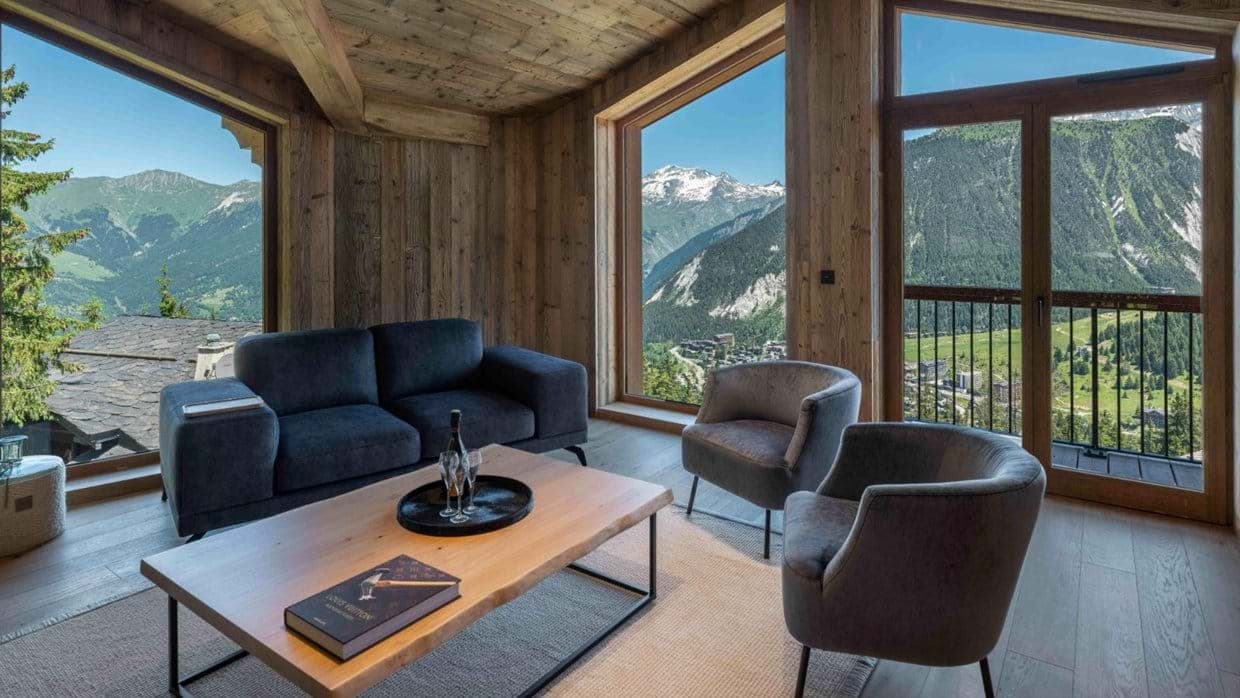 Living area with reclaimed wood walls and alpine valley views