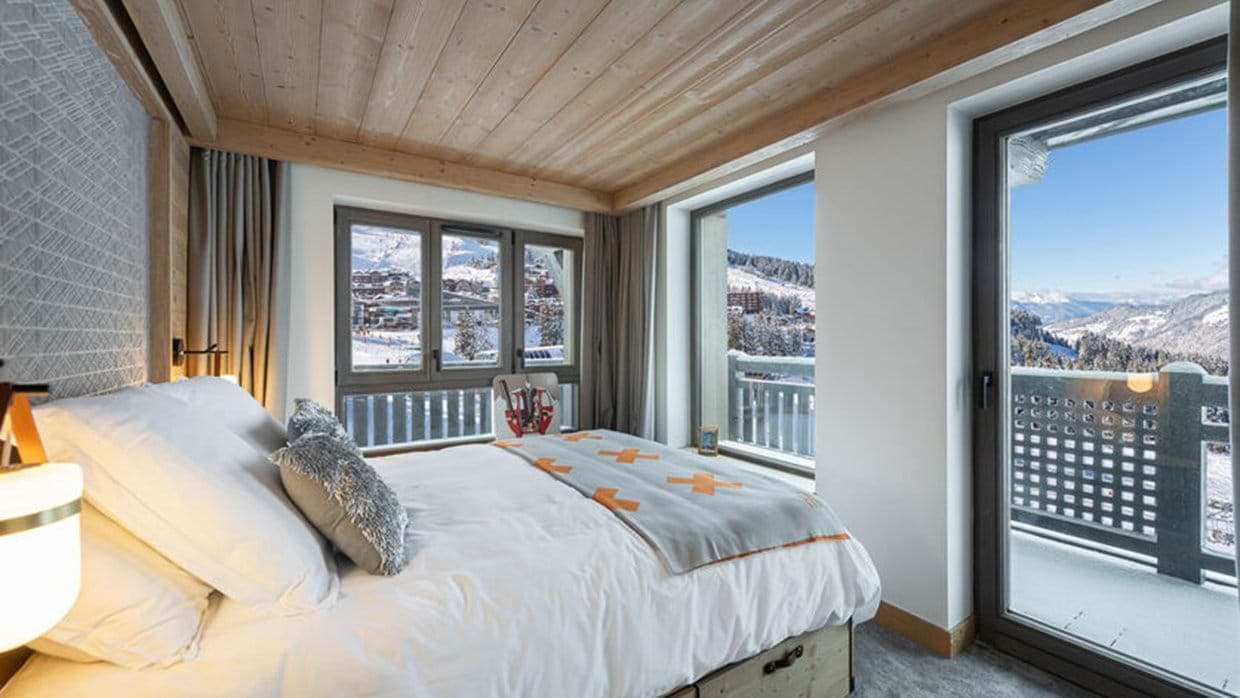 Bedroom with king bed and balcony access; mountain views