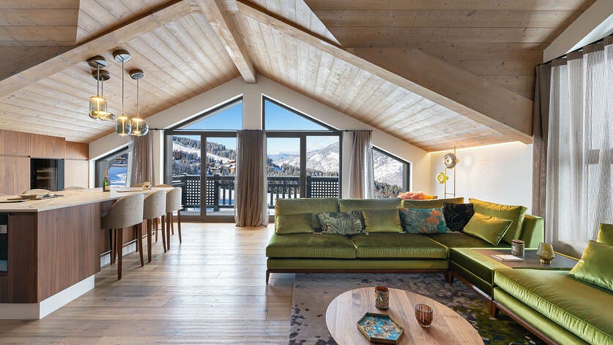Living area with vaulted ceilings and mountain views; island seats 4