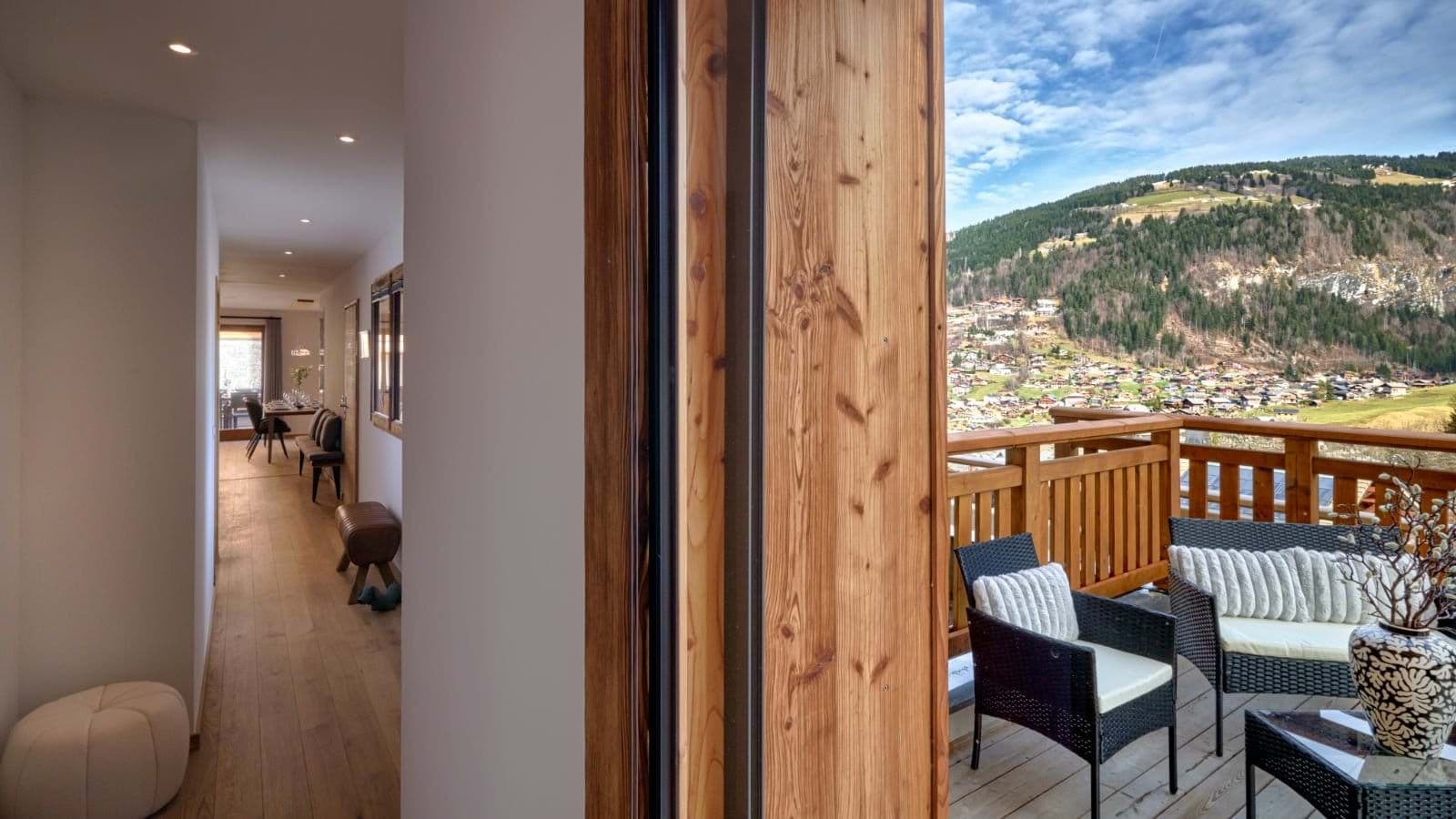 Private balcony with lounge seating and alpine valley views