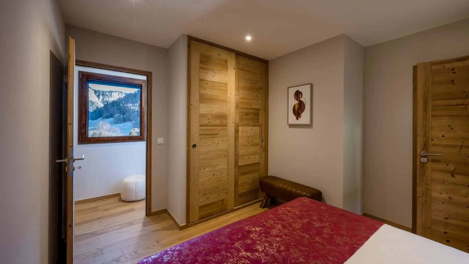 Double bedroom with timber wardrobes and mountain views