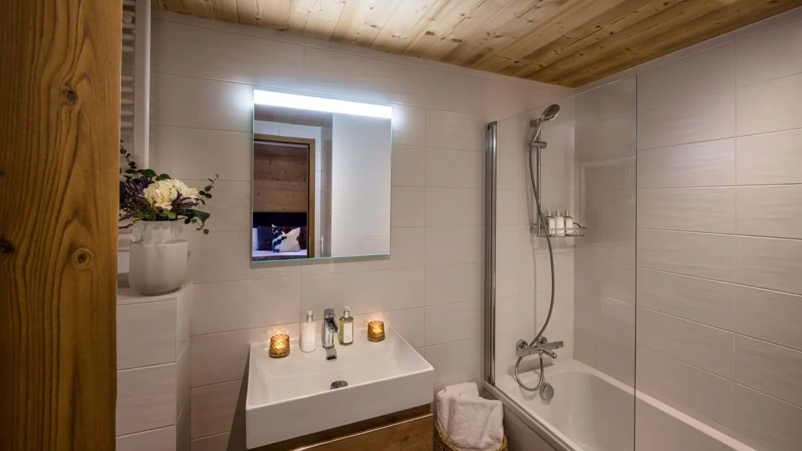 Bathroom with a bathtub, glass shower screen and vanity basin
