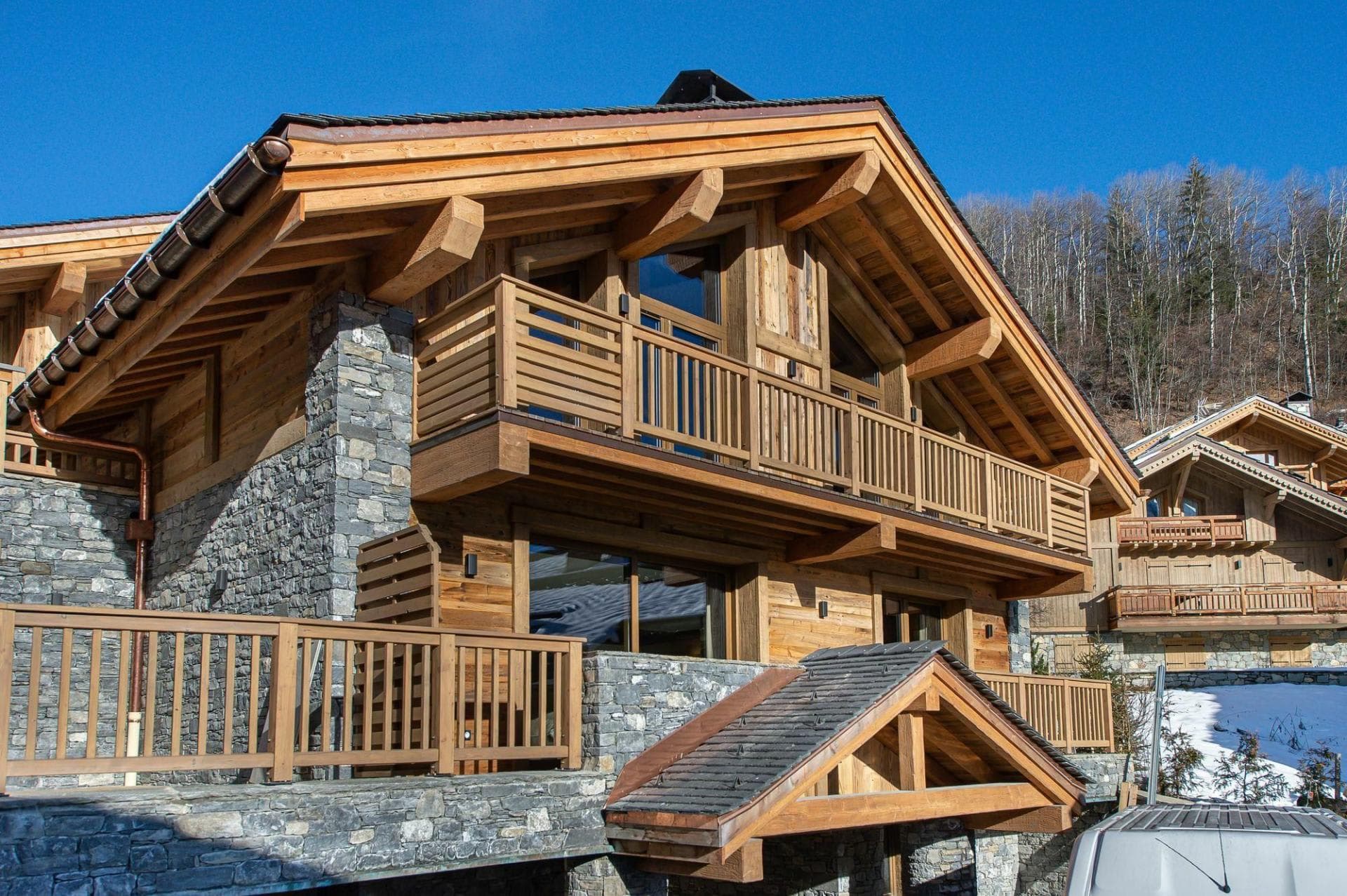 Timber and stone exterior with multi-level wooden balconies