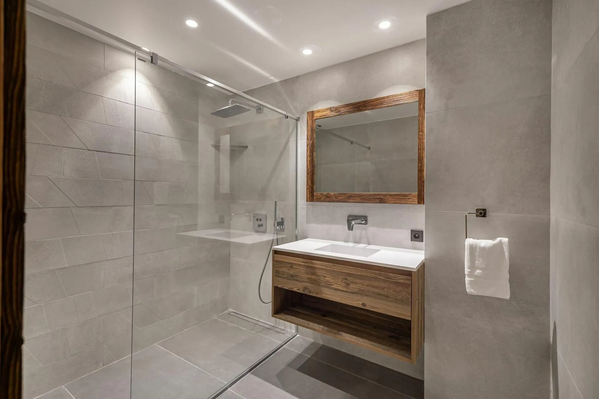 En-suite shower room with a basin and heated towel rail