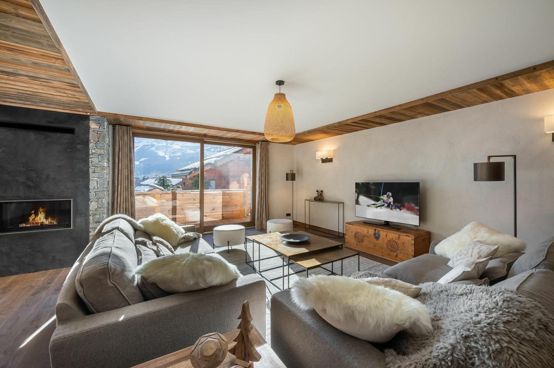 Living room with fireplace and sliding door access to mountain-view balcony