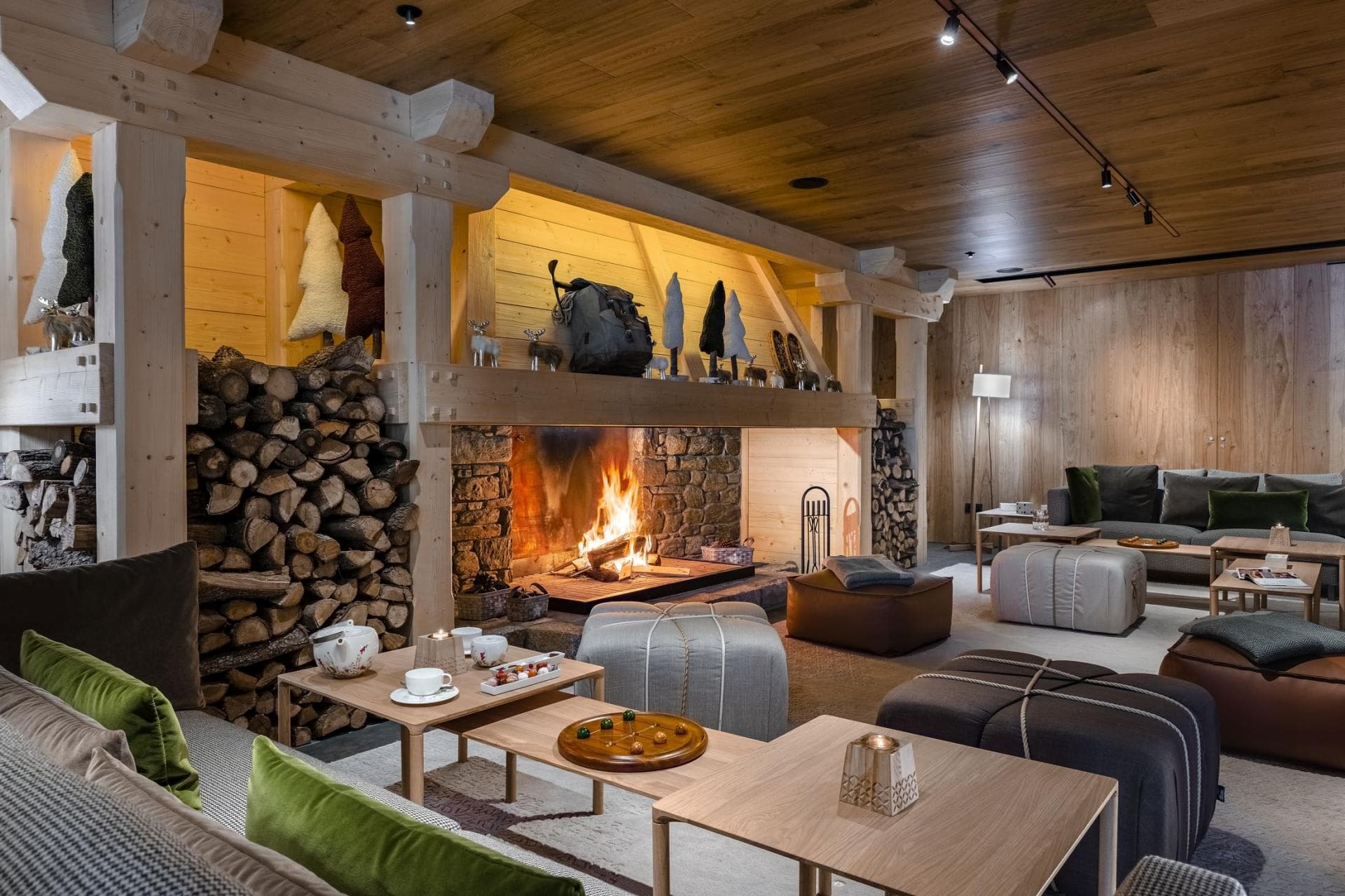 Lounge area with wood-burning stone fireplace and modular pouf seating