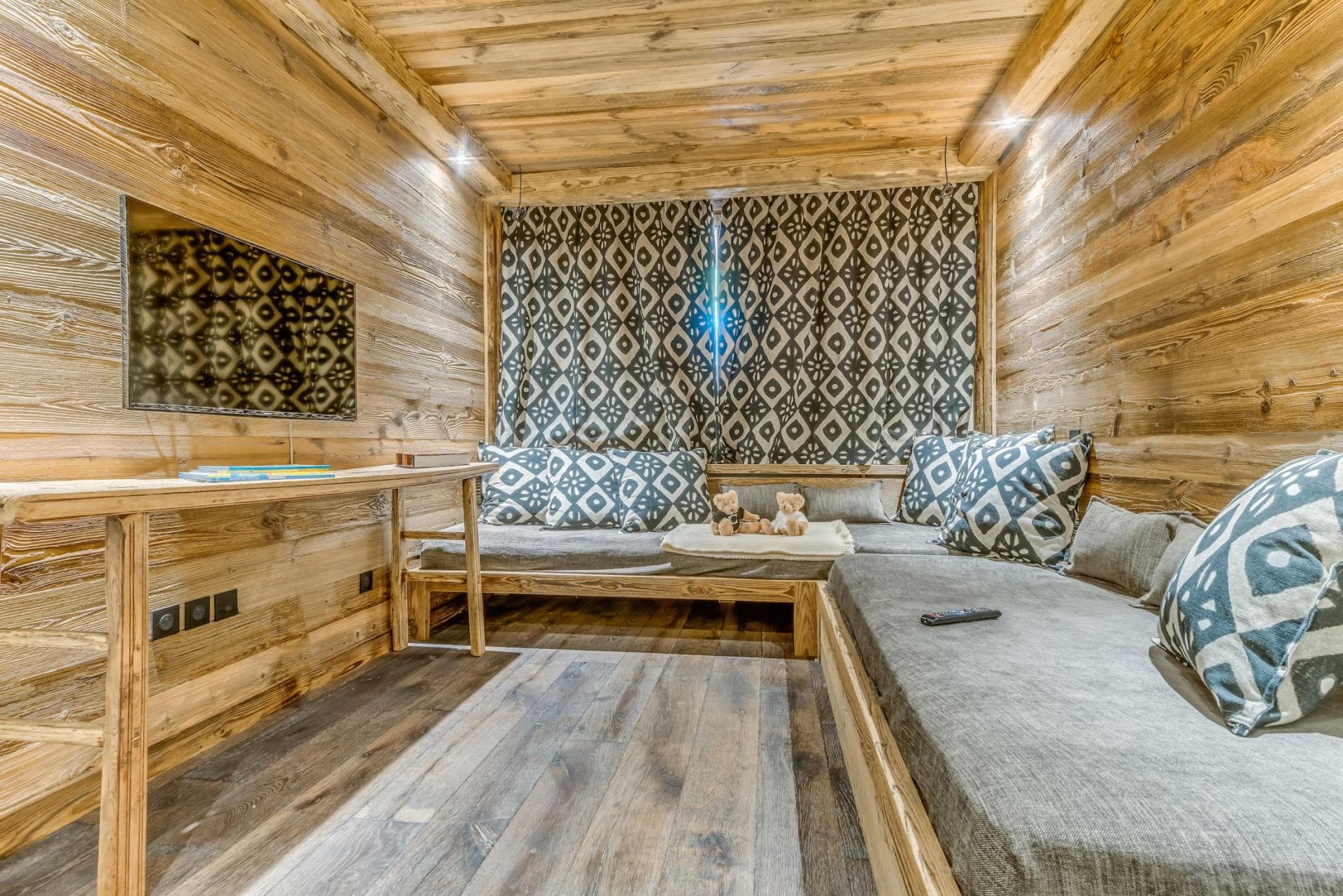 Media room with reclaimed wood walls and built-in daybed seating