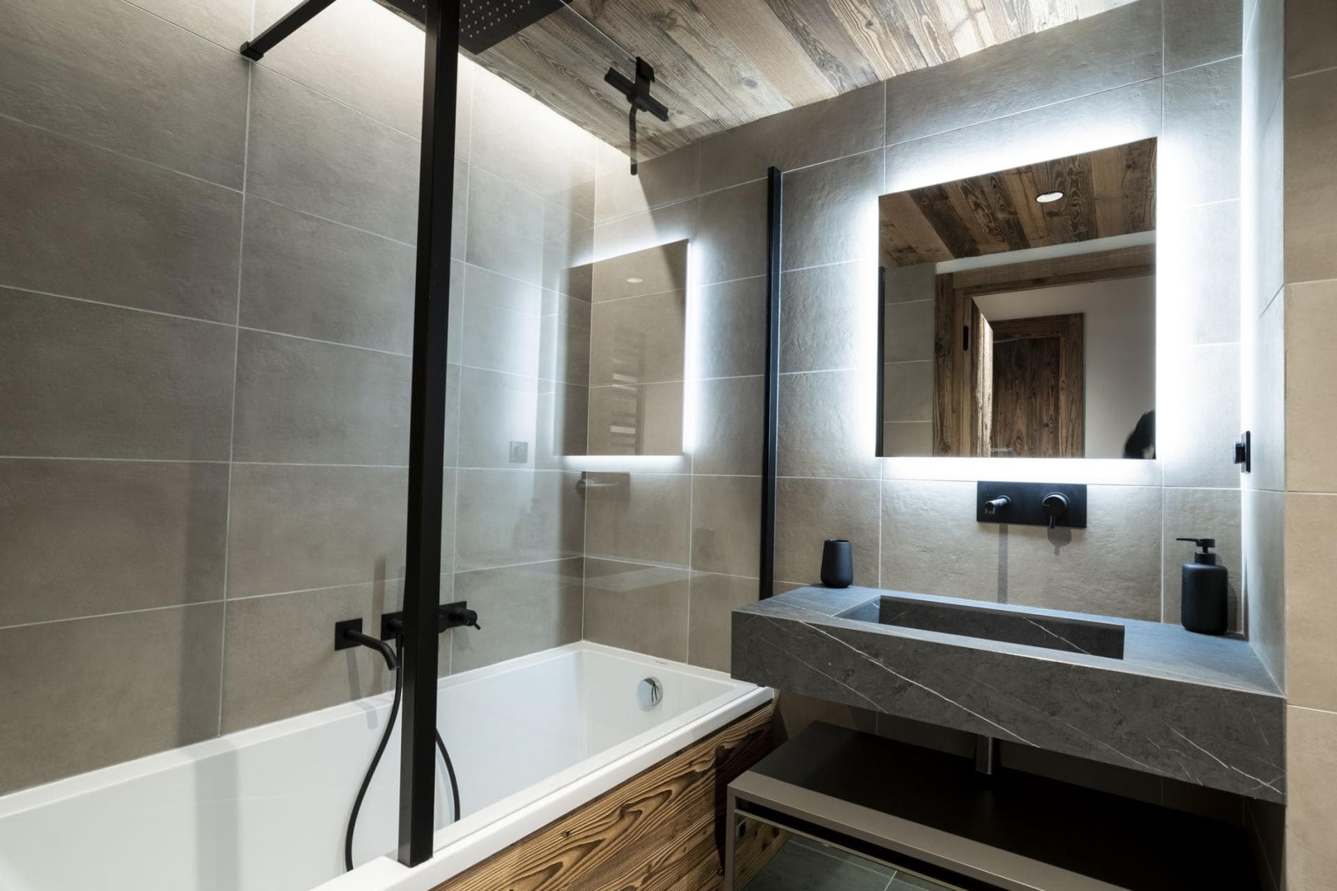 Bathroom with rainfall shower head, soaking tub, and stone vanity