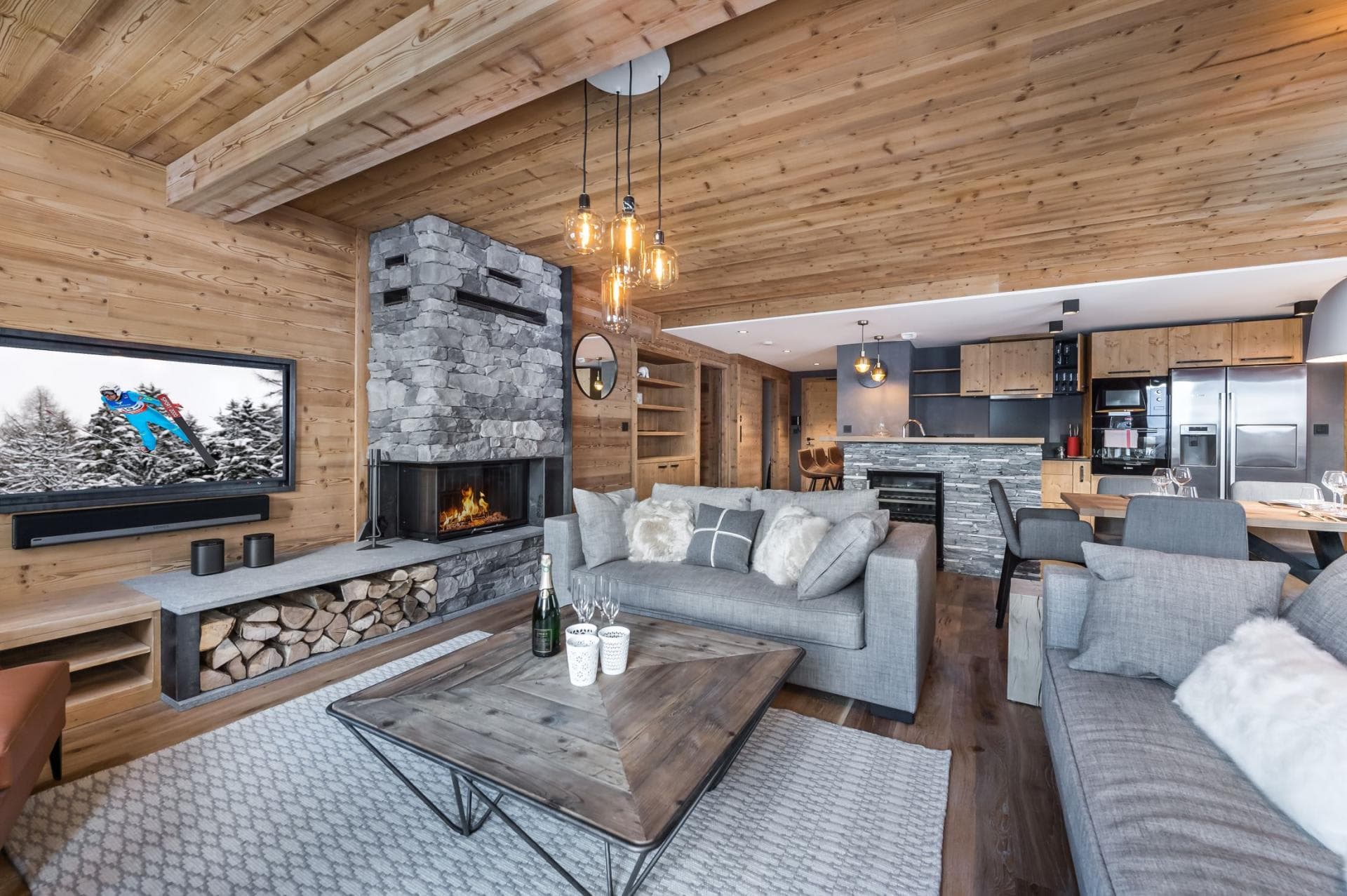 Open living area with wood-burning fireplace and wine cooler