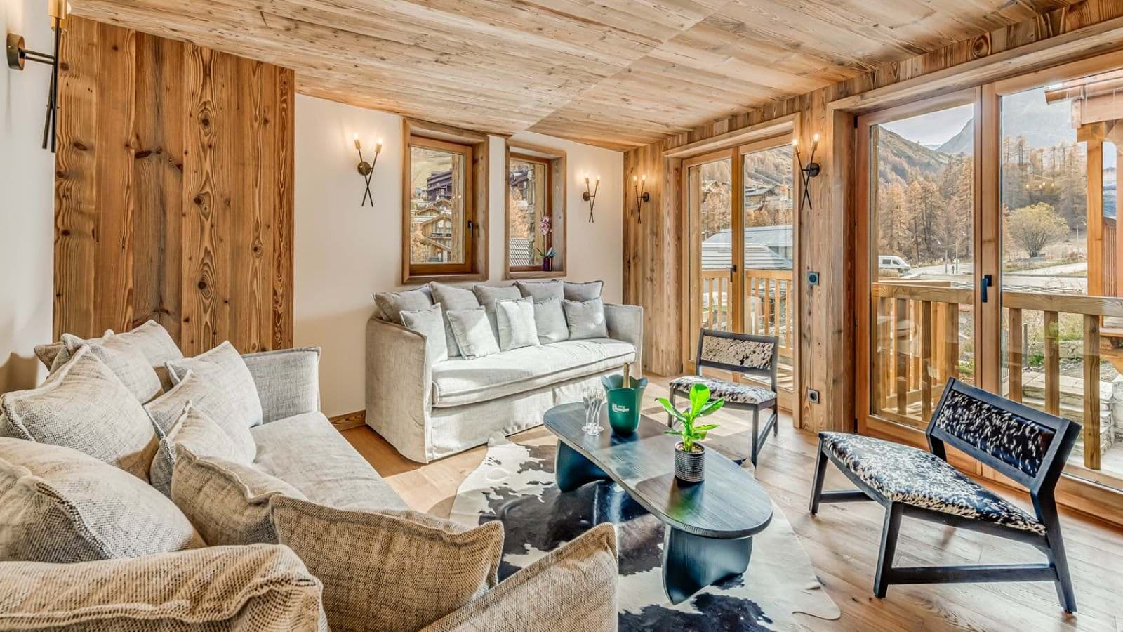 Living area with sofa seating for 6 and balcony access