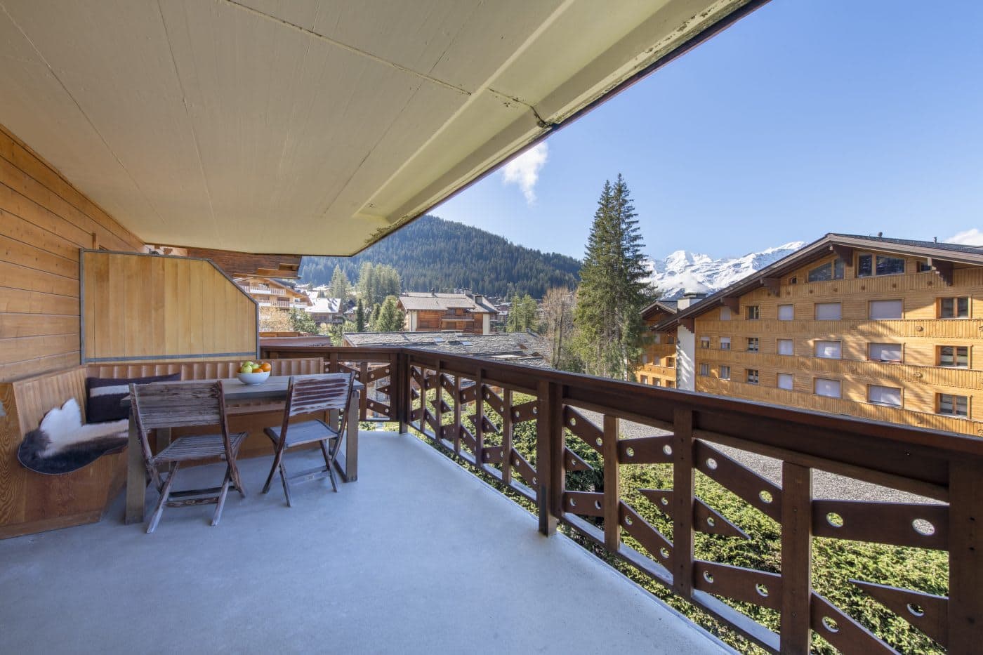 Covered balcony with dining for 4 and snow-capped mountain views