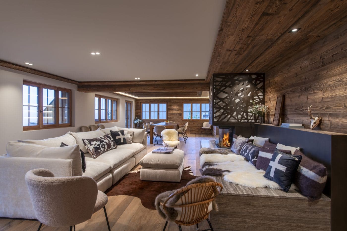 Living room with sectional sofa, wood-burning fireplace, and dining area