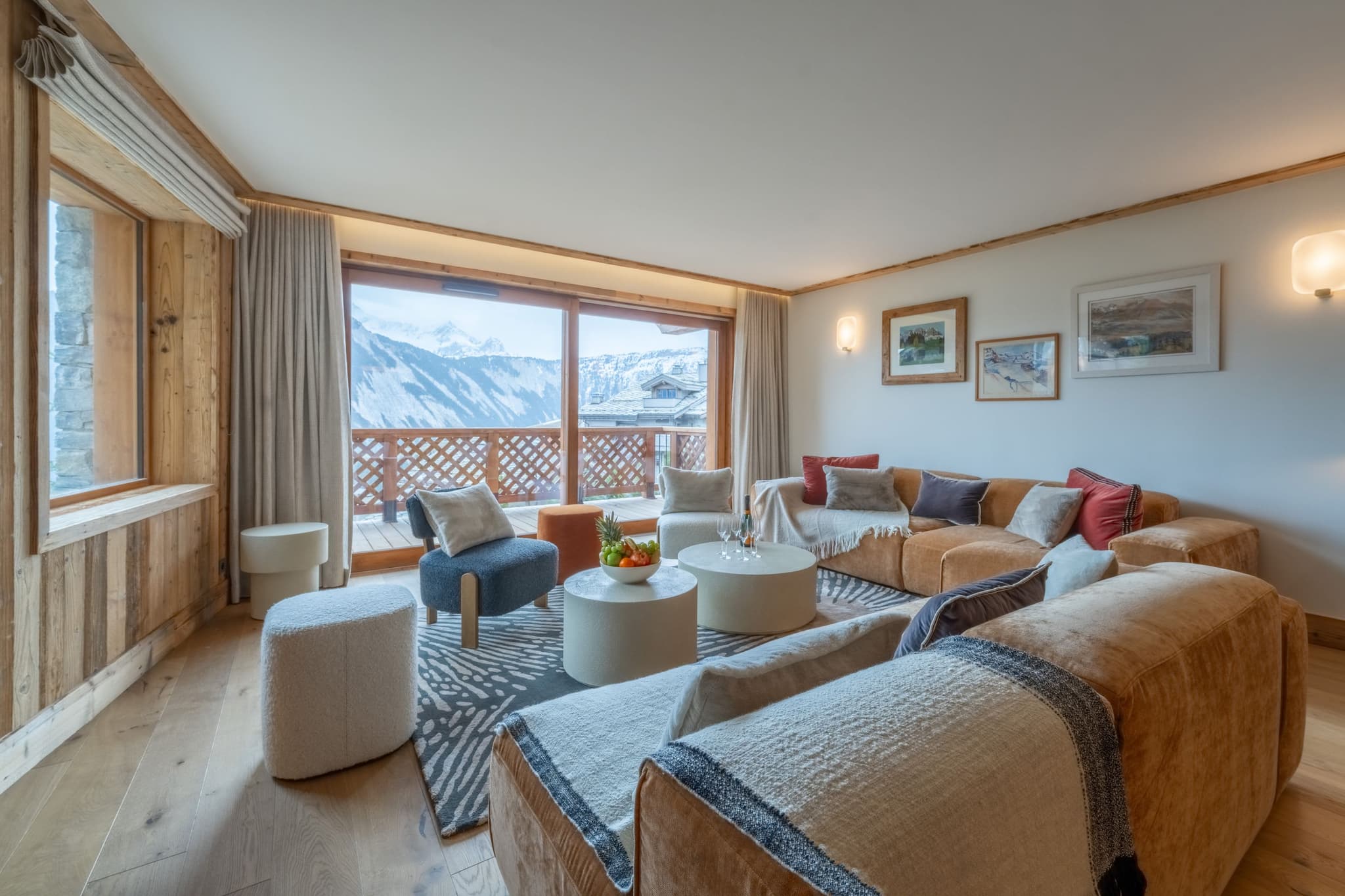 Living area with mountain-view balcony and sectional seating for 8