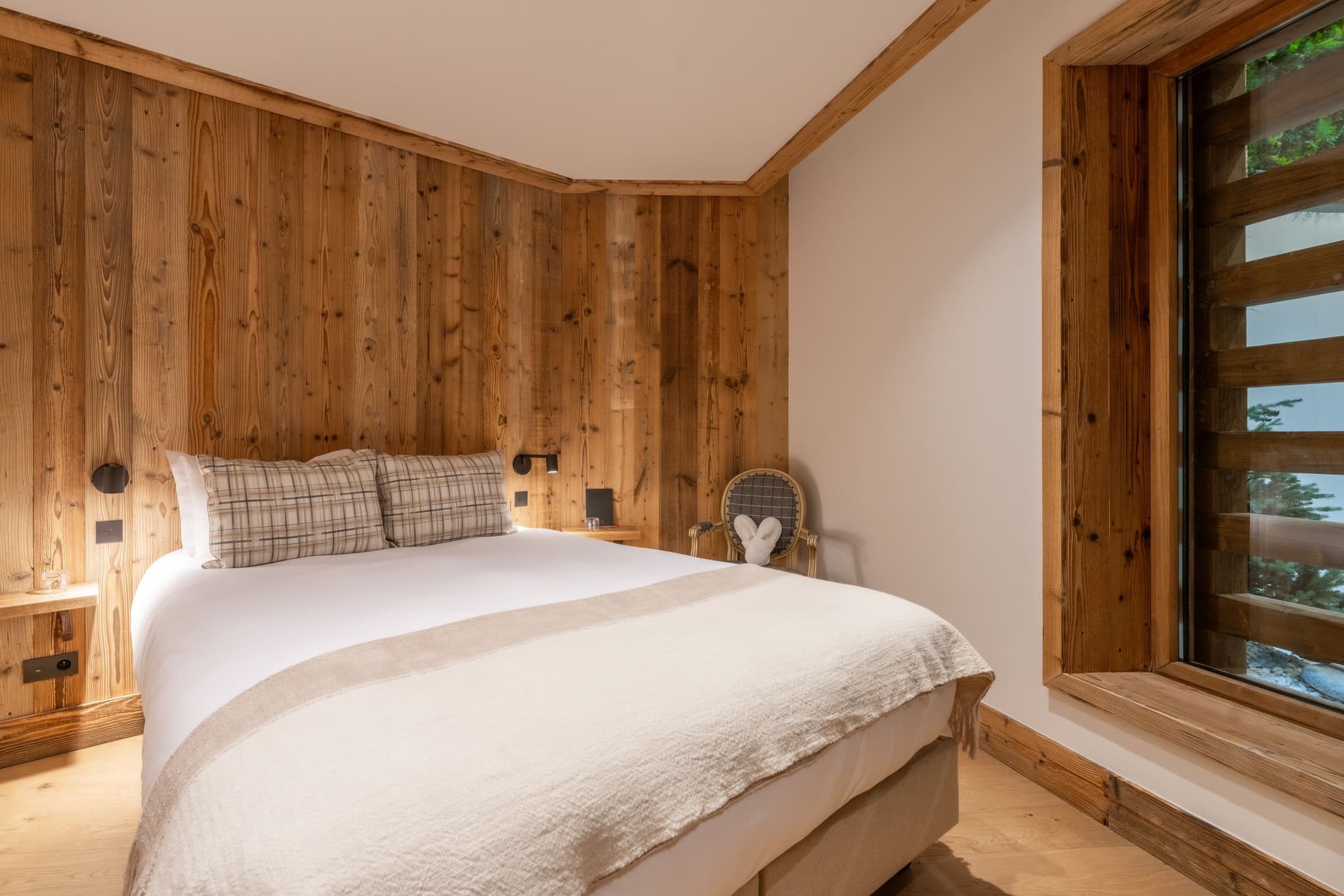 Guest bedroom with queen bed and reclaimed wood paneling