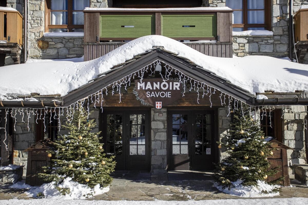 Manoir Savoie main entrance featuring stone facade and timber accents