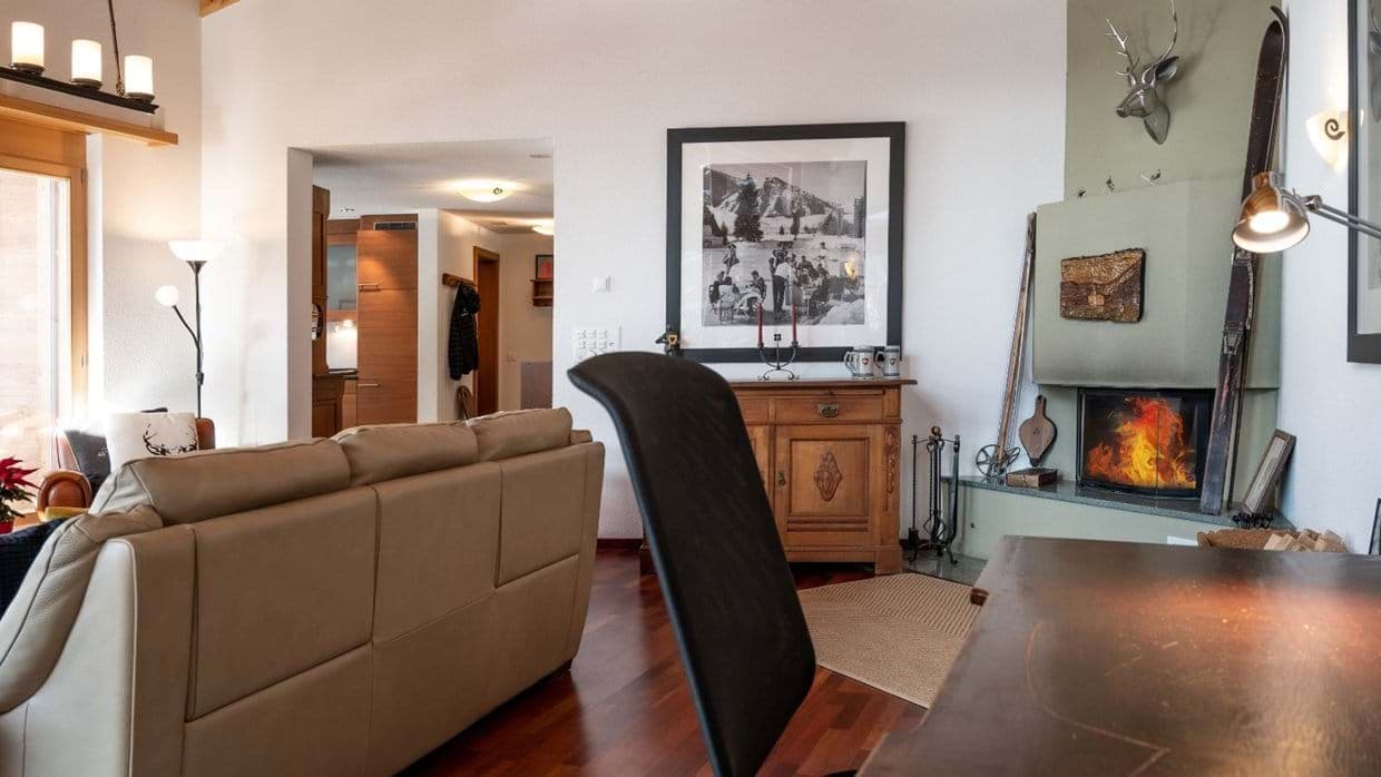 Living room with corner fireplace and dedicated desk for remote work