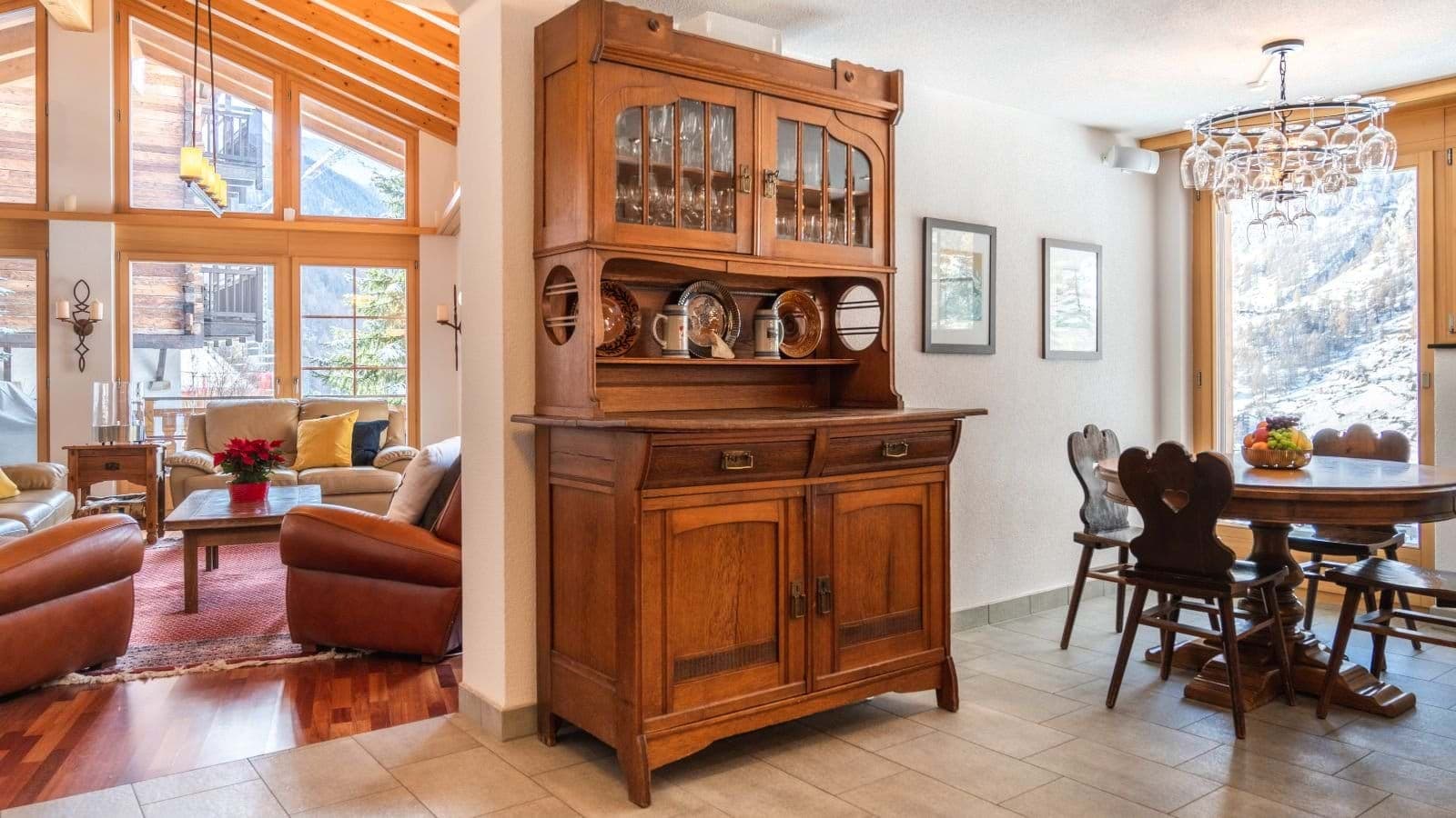 Dining area with wine glass chandelier and floor-to-ceiling mountain views
