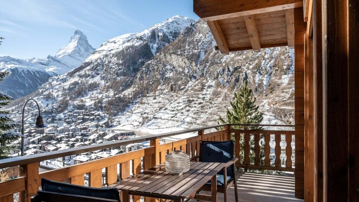 Private balcony with wooden table and direct views of the Matterhorn