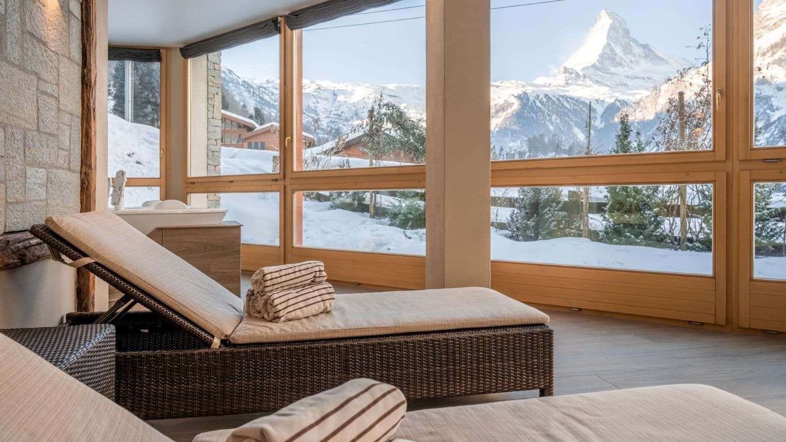 Indoor spa area with lounge chairs and Matterhorn mountain views