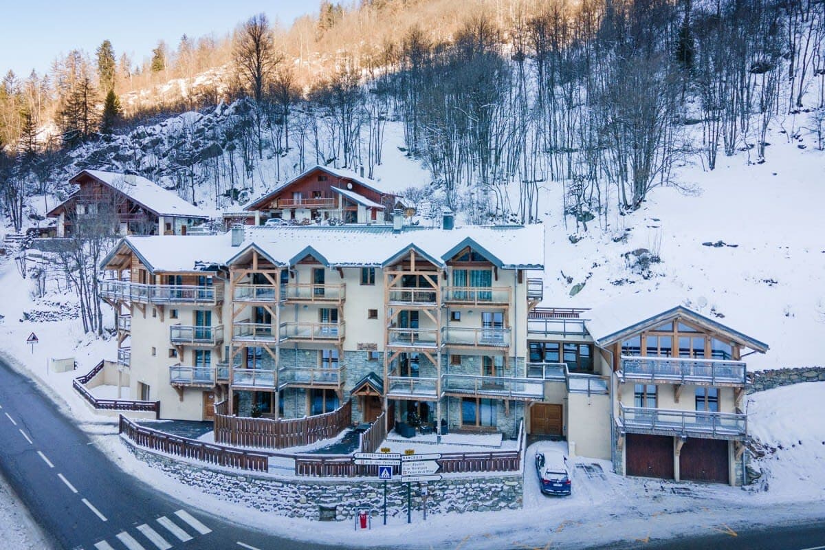 Ski-in/ski-out lodge exterior with private balconies and garage parking