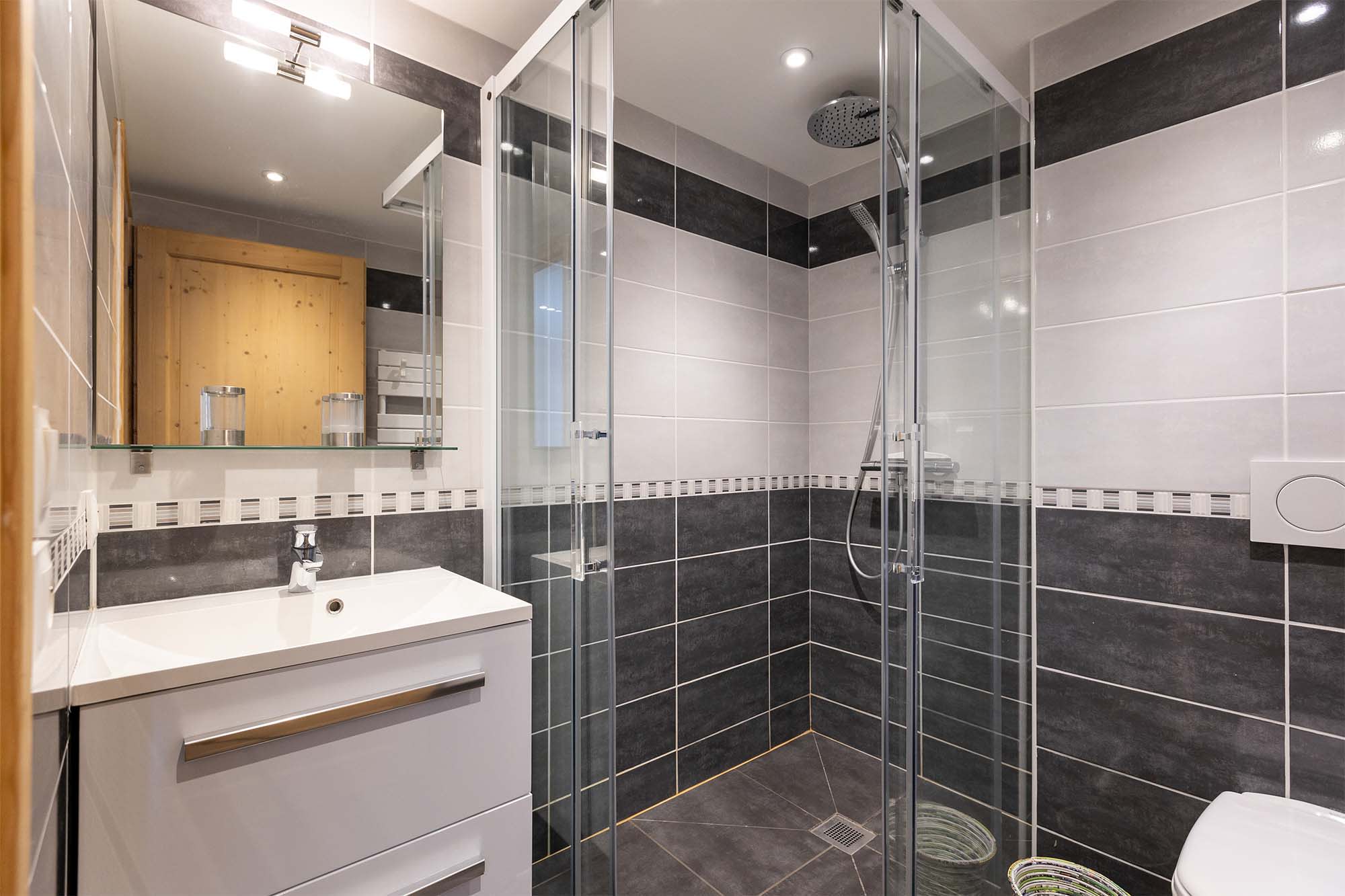 Bathroom with walk-in rainfall shower and single vanity