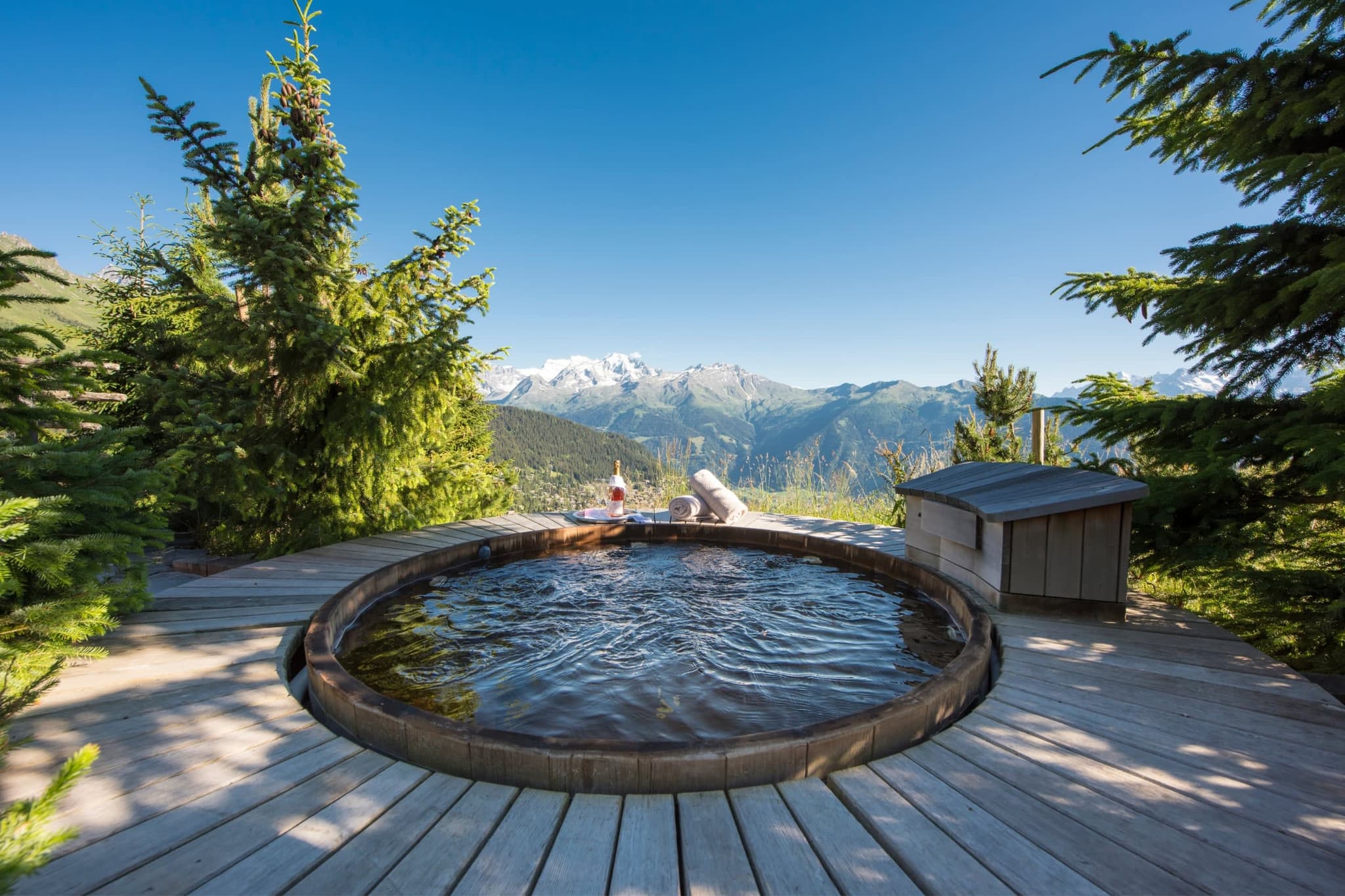 Sunken wooden hot tub with panoramic mountain views