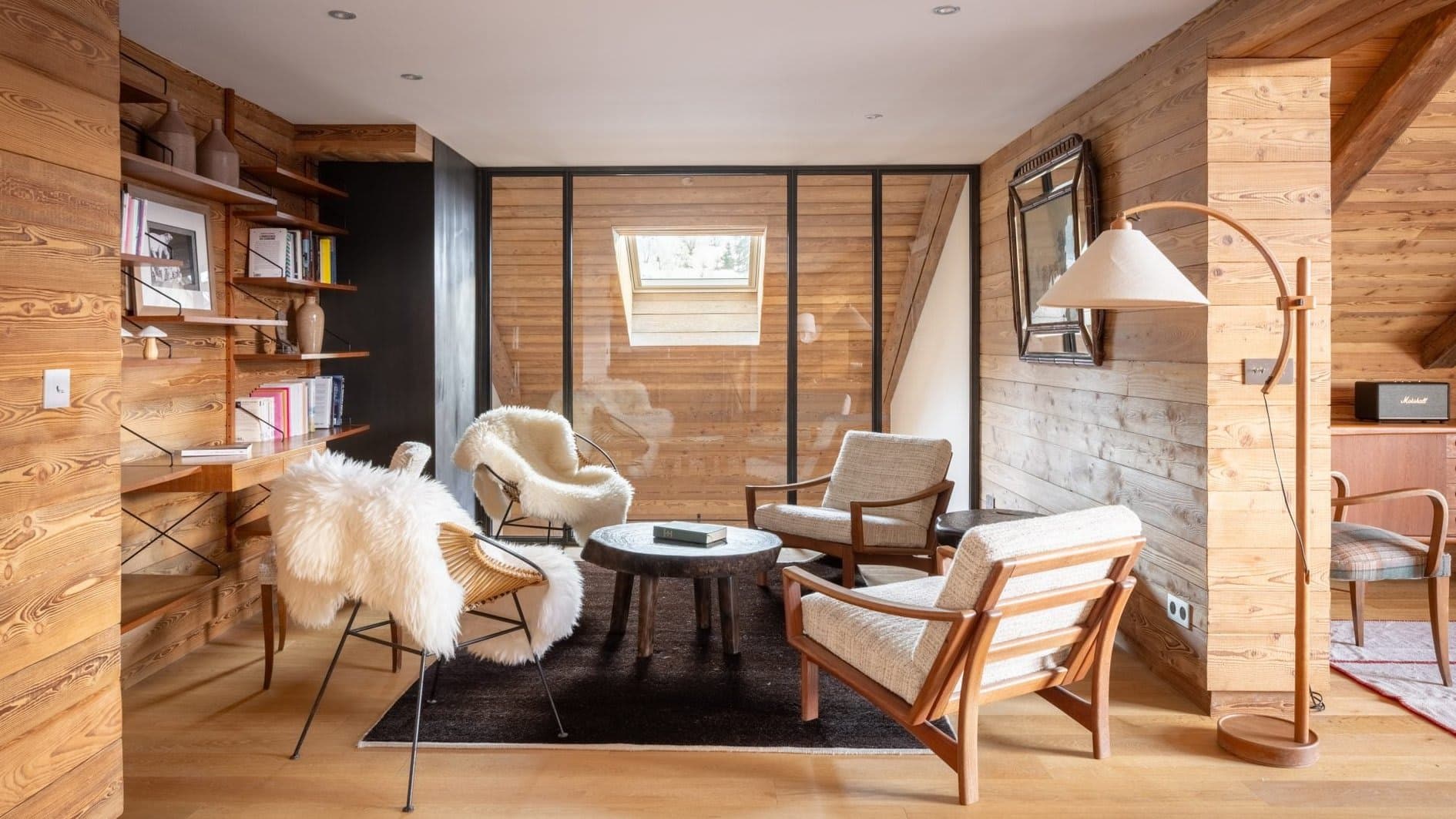 Lounge area with desk, shelving, and glass partition wall