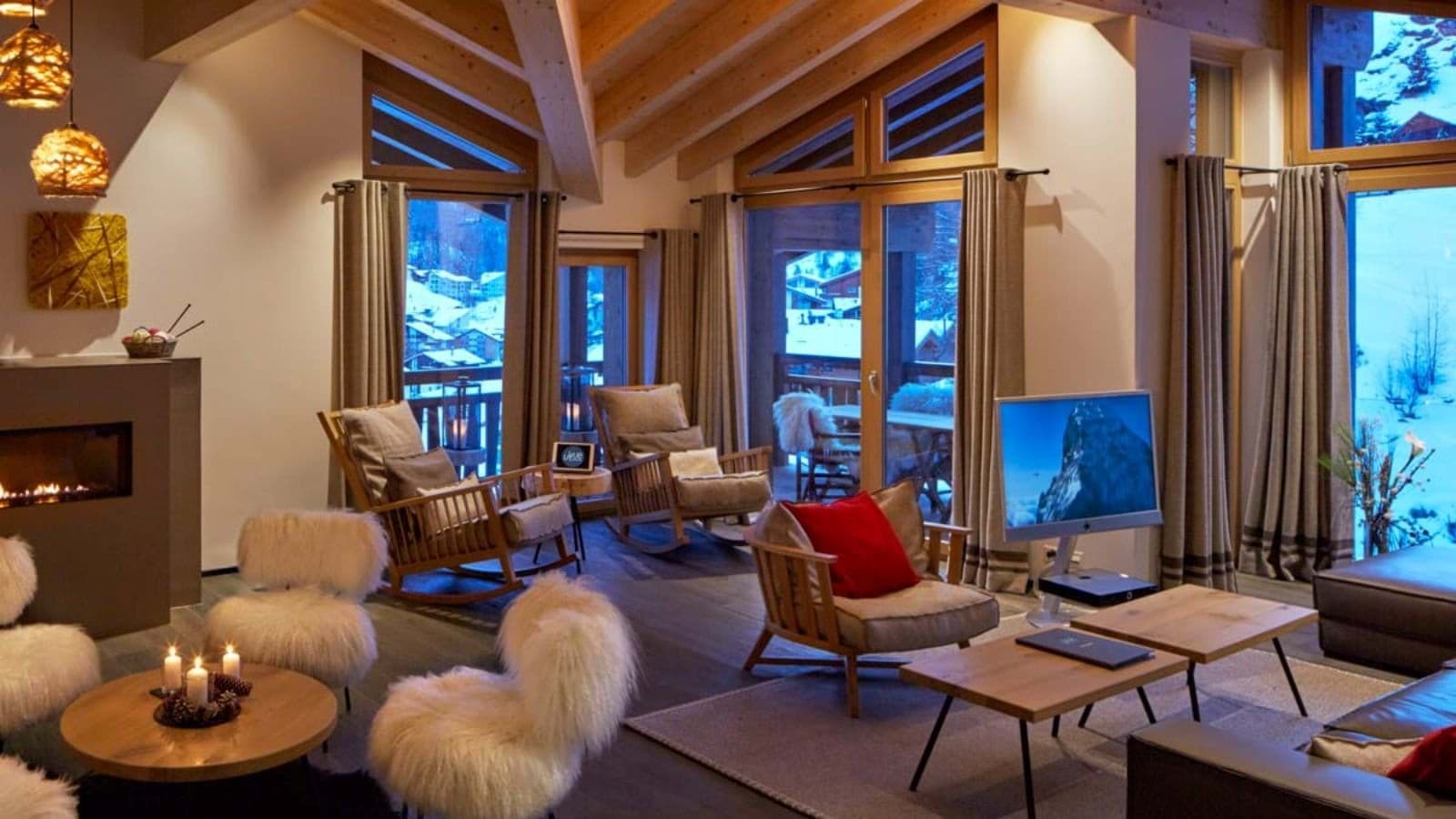 Living area with wood-burning fireplace and mountain-view balcony access