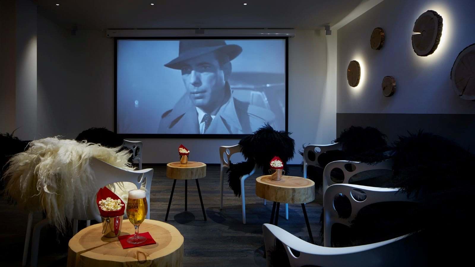 Private cinema room with projector screen and seating for at least 6