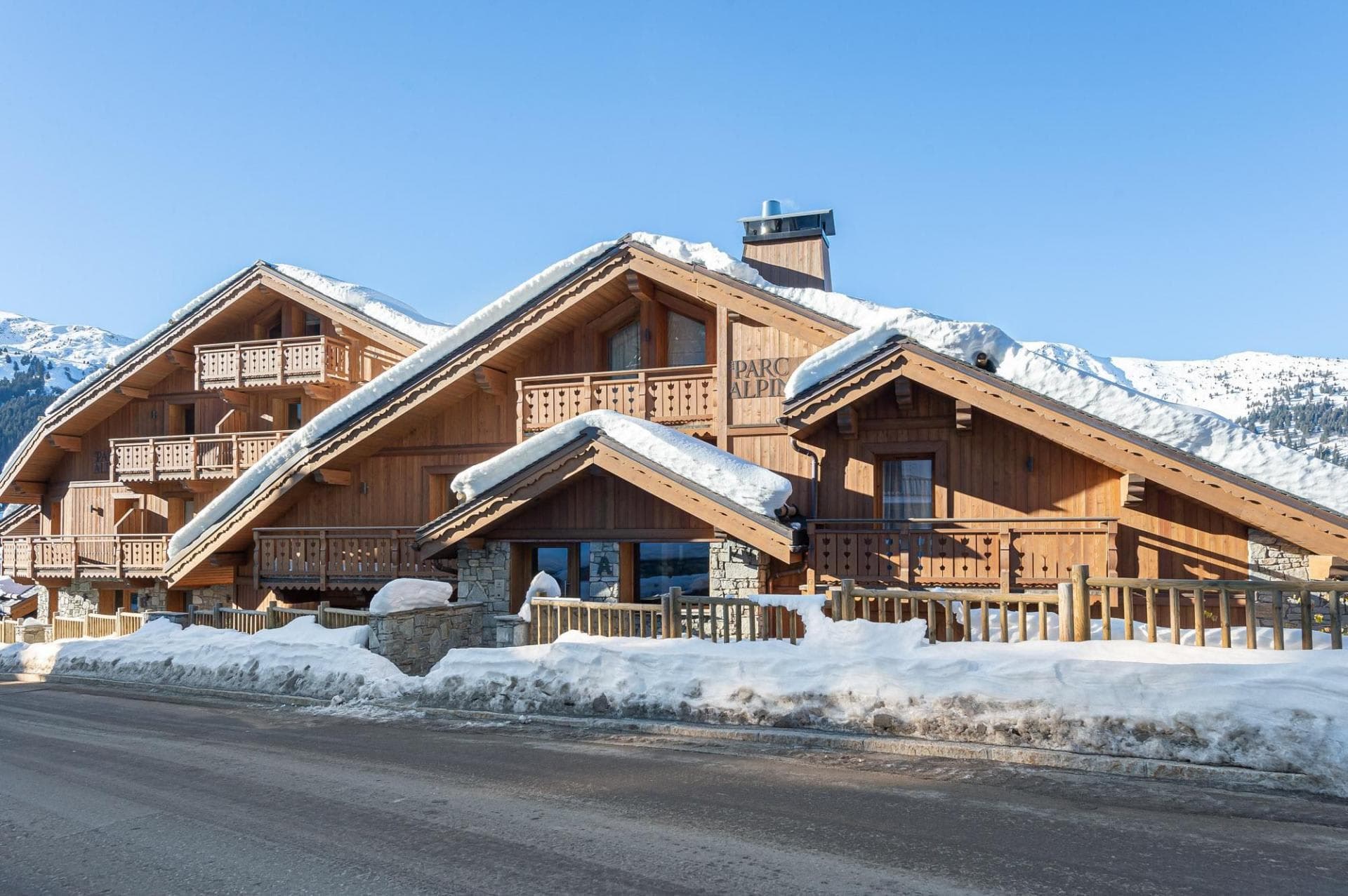 Chalet exterior with multiple private balconies and direct road access