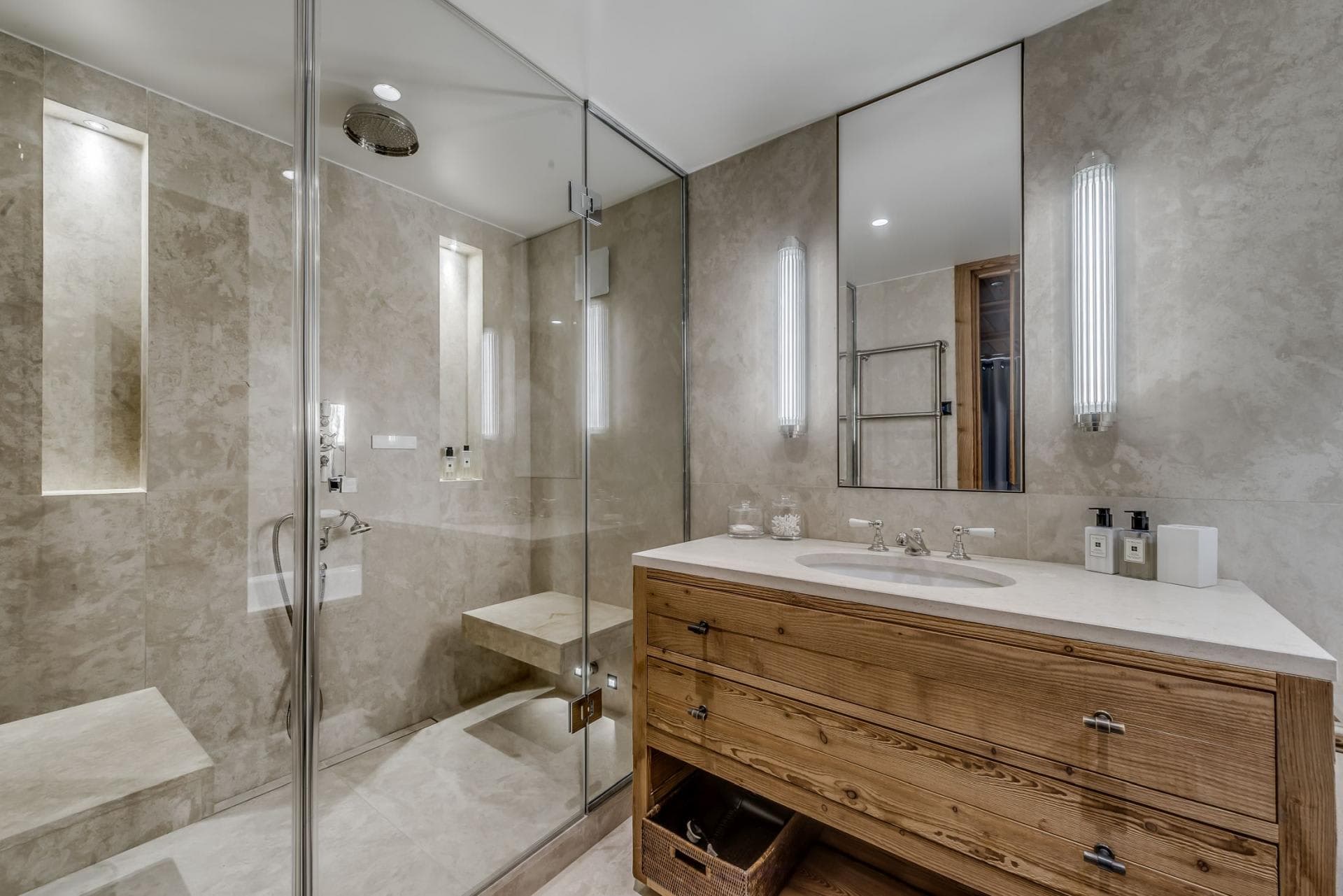 Bathroom with walk-in rainfall shower, stone bench, and timber vanity