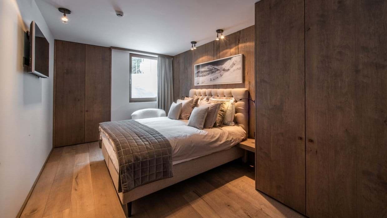 Bedroom with king bed and floor-to-ceiling built-in wood closets