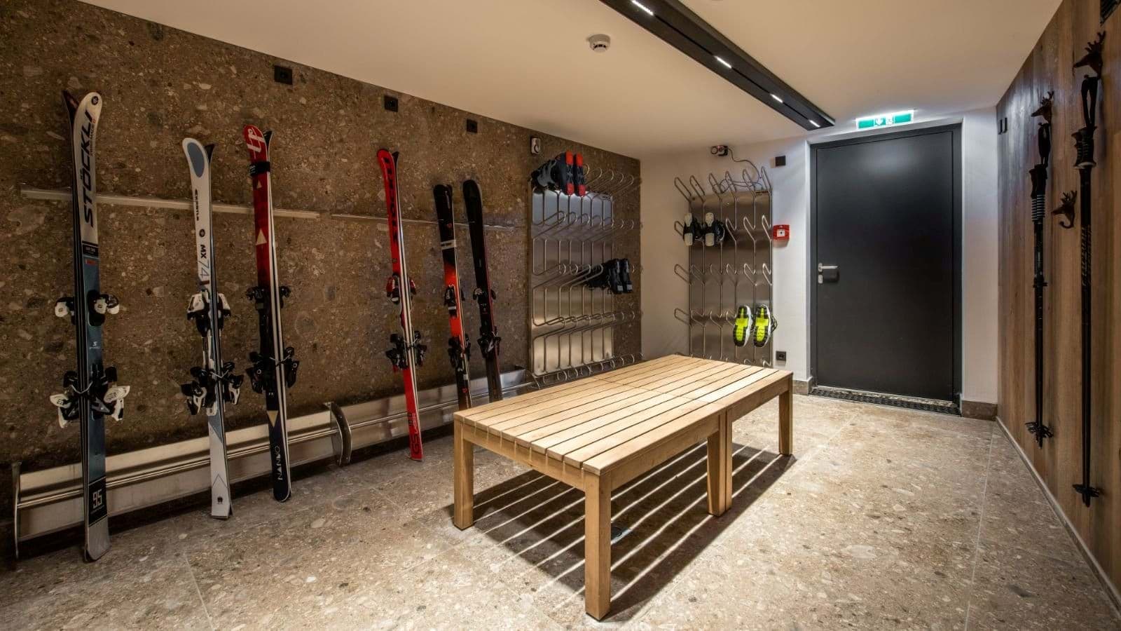 Ski room with wall-mounted storage and heated boot dryers