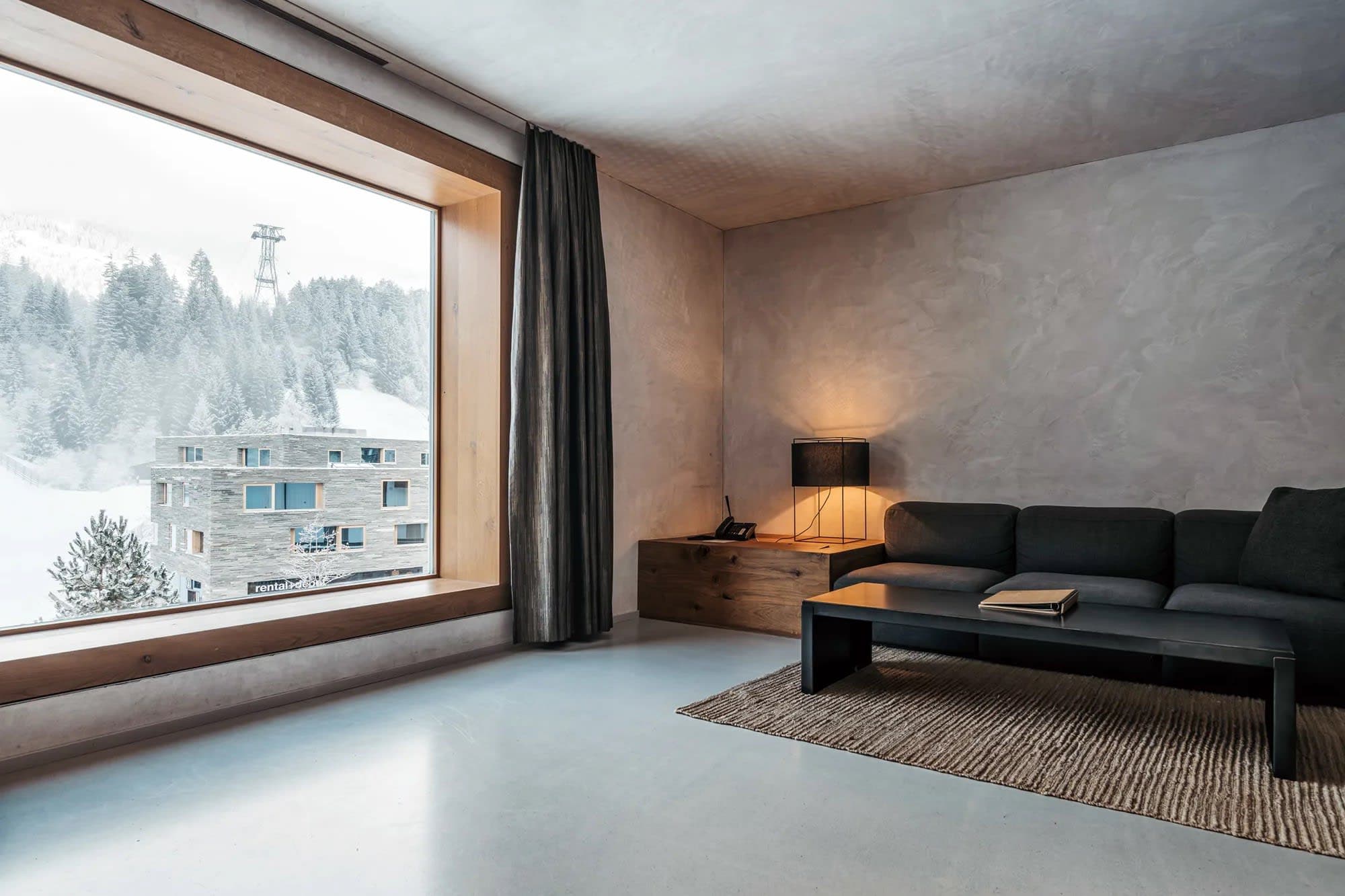 Living area with picture window overlooking ski slopes and lift