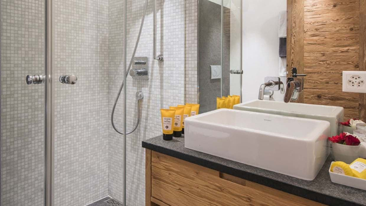 Bathroom featuring walk-in glass shower and vanity with vessel sink